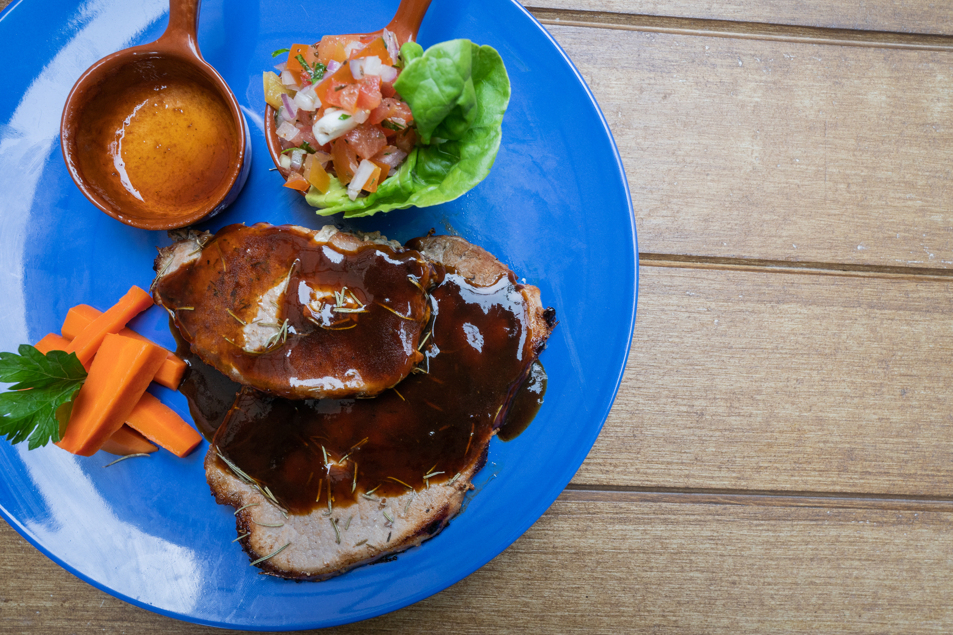 Overhead flat-lay of all ingredients for Puerto Rican Pernil with Mojo Sauce laid out on a kitchen surface.