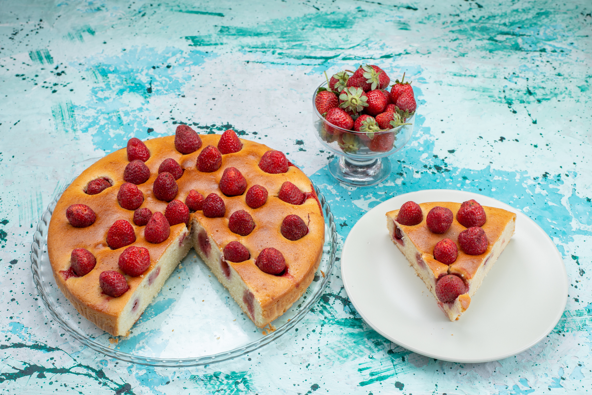 Overhead flat-lay of all ingredients for Raspberry-Glazed Polish Sernik with Almond Biscuit Base laid out on a kitchen surface.