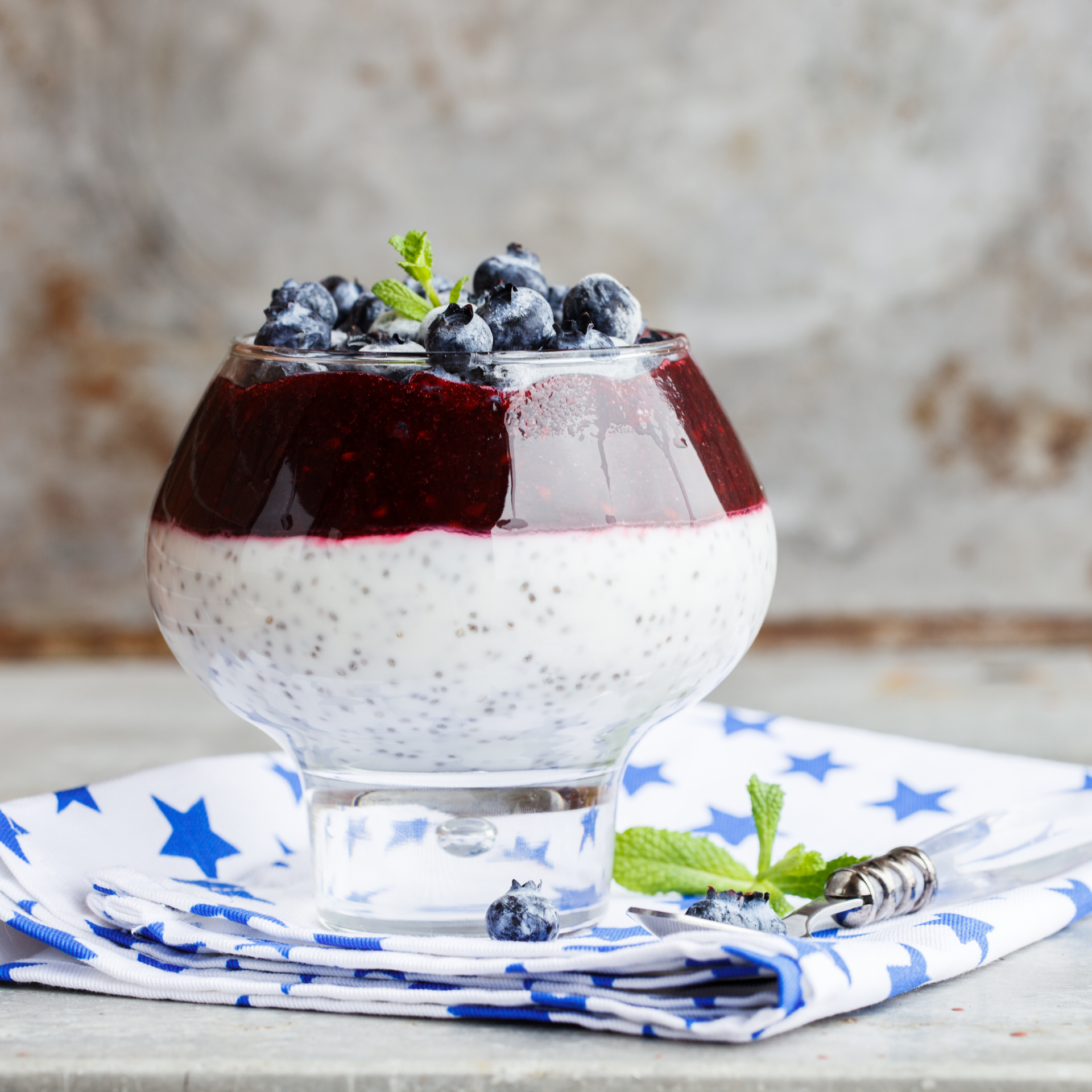 Overhead flat-lay of all ingredients for Refreshing Icelandic Skyr Mousse with Blueberry Compote laid out on a kitchen surface.