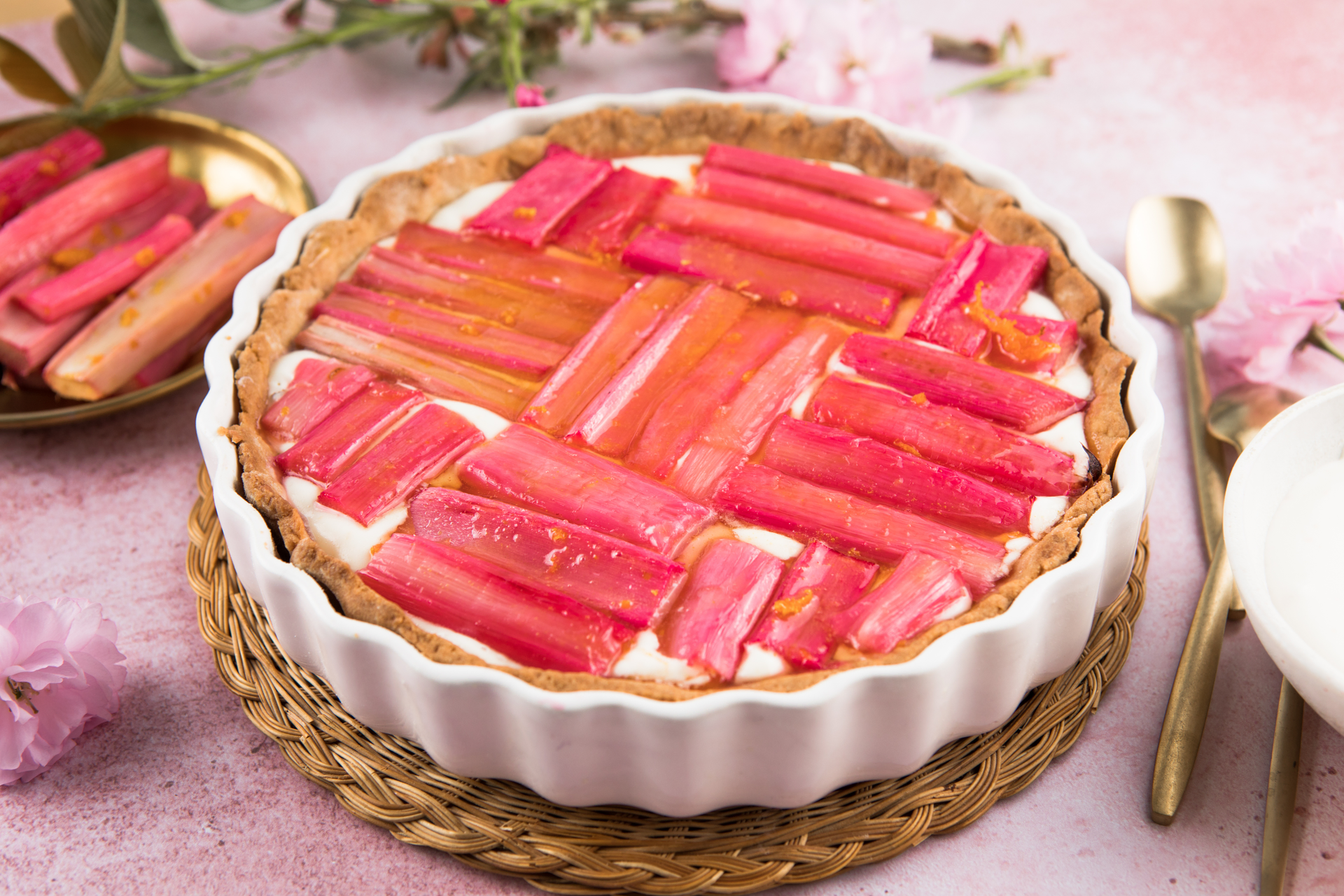 Overhead flat-lay of all ingredients for Rhubarb and Strawberry Tarte with Almond Crust laid out on a kitchen surface.