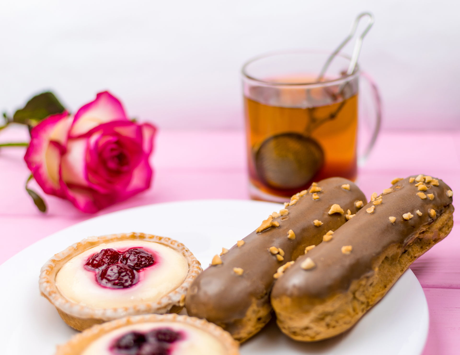 Overhead flat-lay of all ingredients for Rich Belgian Chocolate Éclair with Custard and Raspberry Compote laid out on a kitchen surface.
