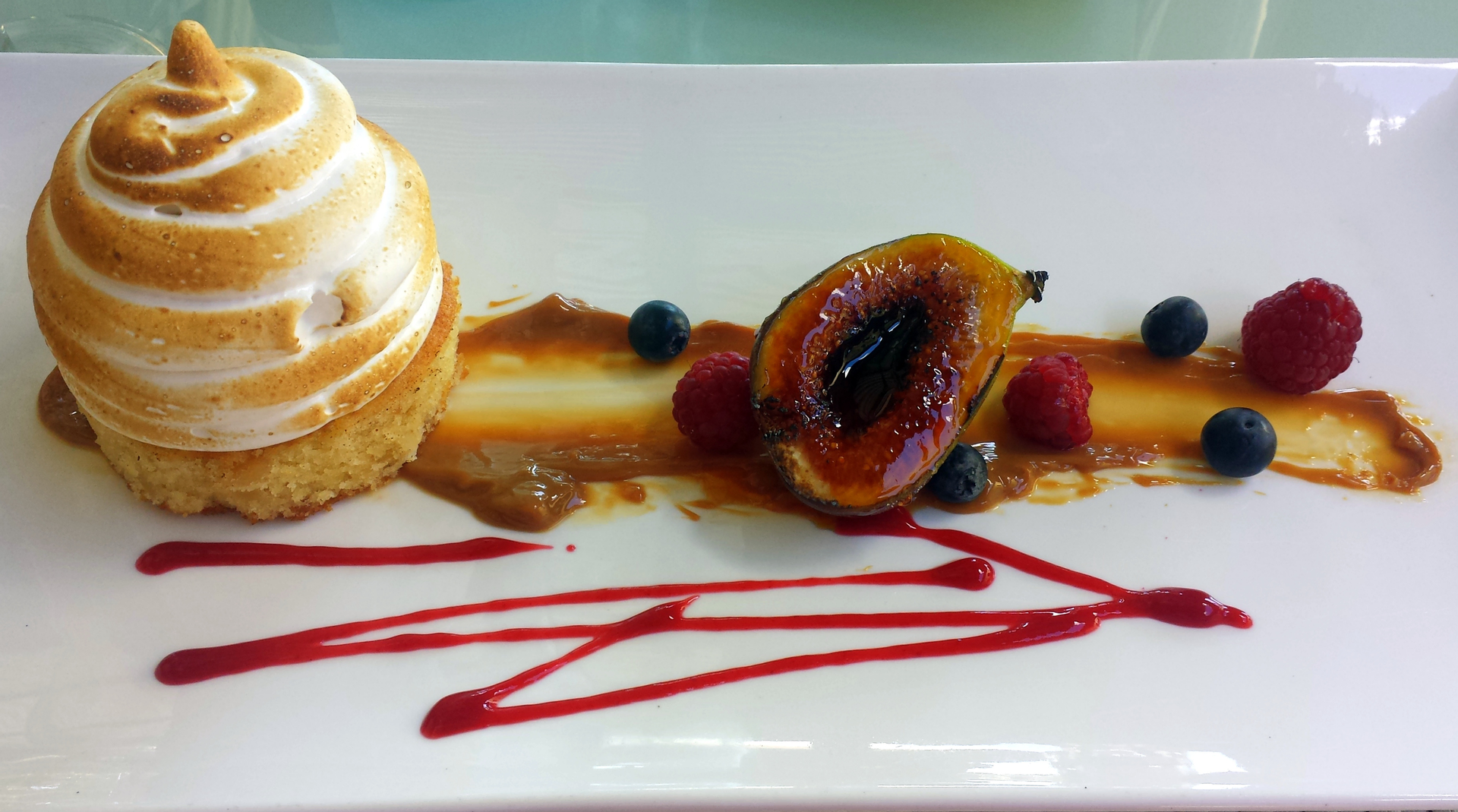 Rich Belgian Chocolate Éclair with Custard and Raspberry Compote — Dessert served and photographed from above