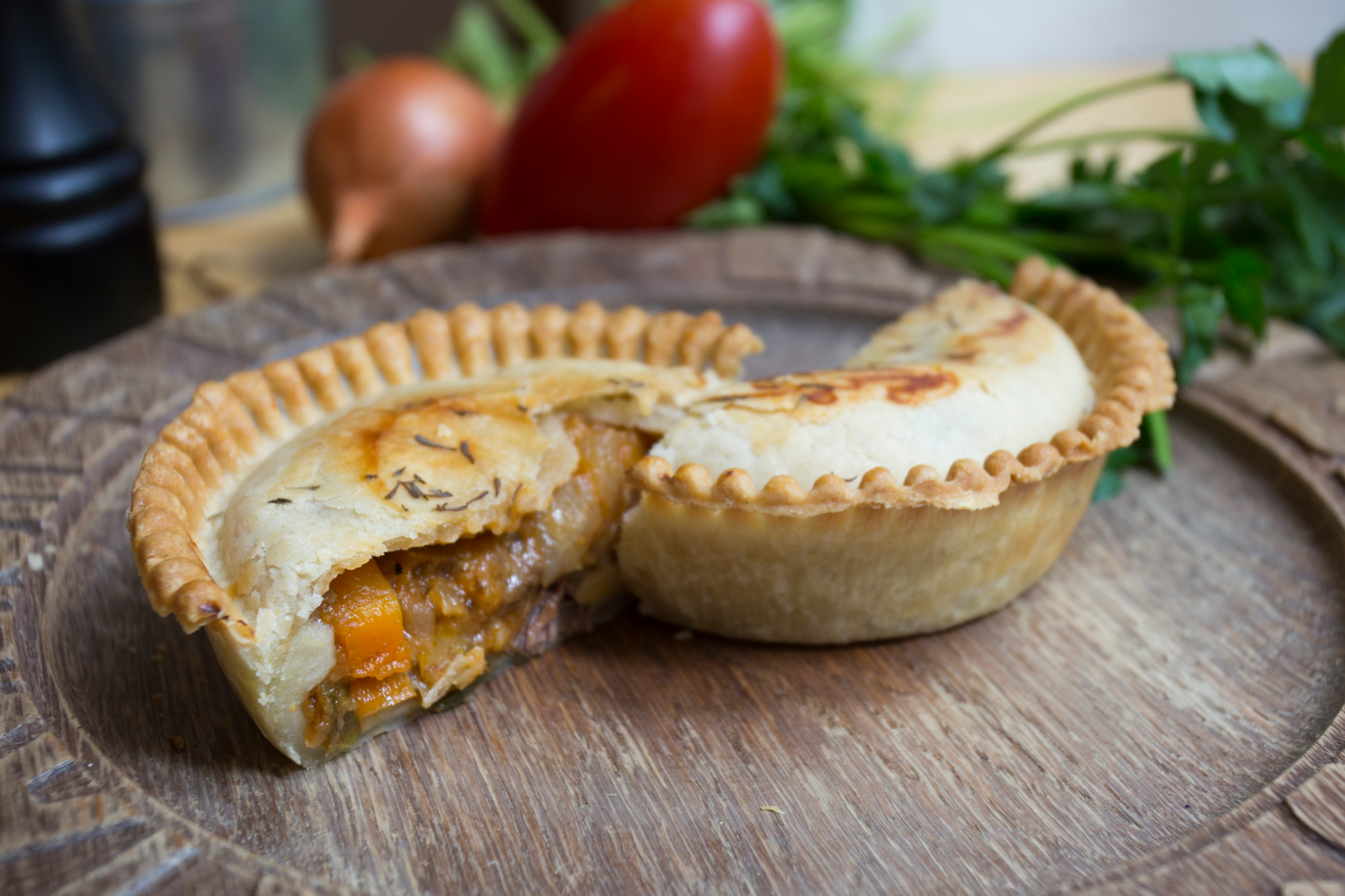 Overhead flat-lay of all ingredients for Rich Canadian Tourtière with Pork and Veal laid out on a kitchen surface.