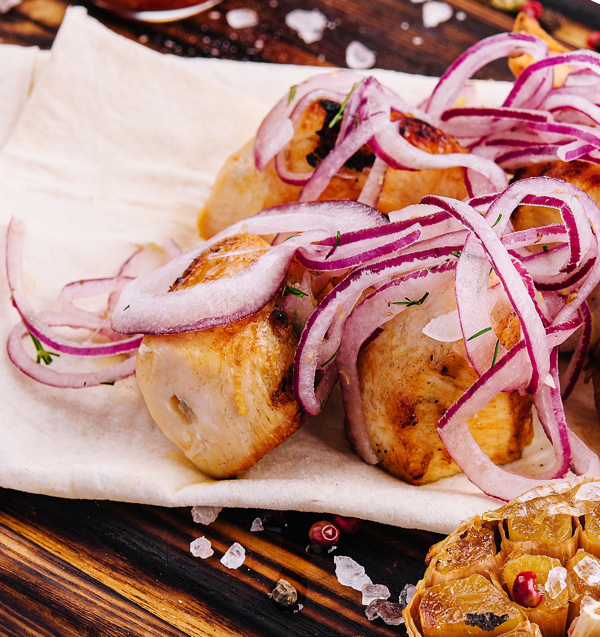 Overhead flat-lay of all ingredients for Rich Dominican Tostones y Salami with Pickled Onion Slaw laid out on a kitchen surface.