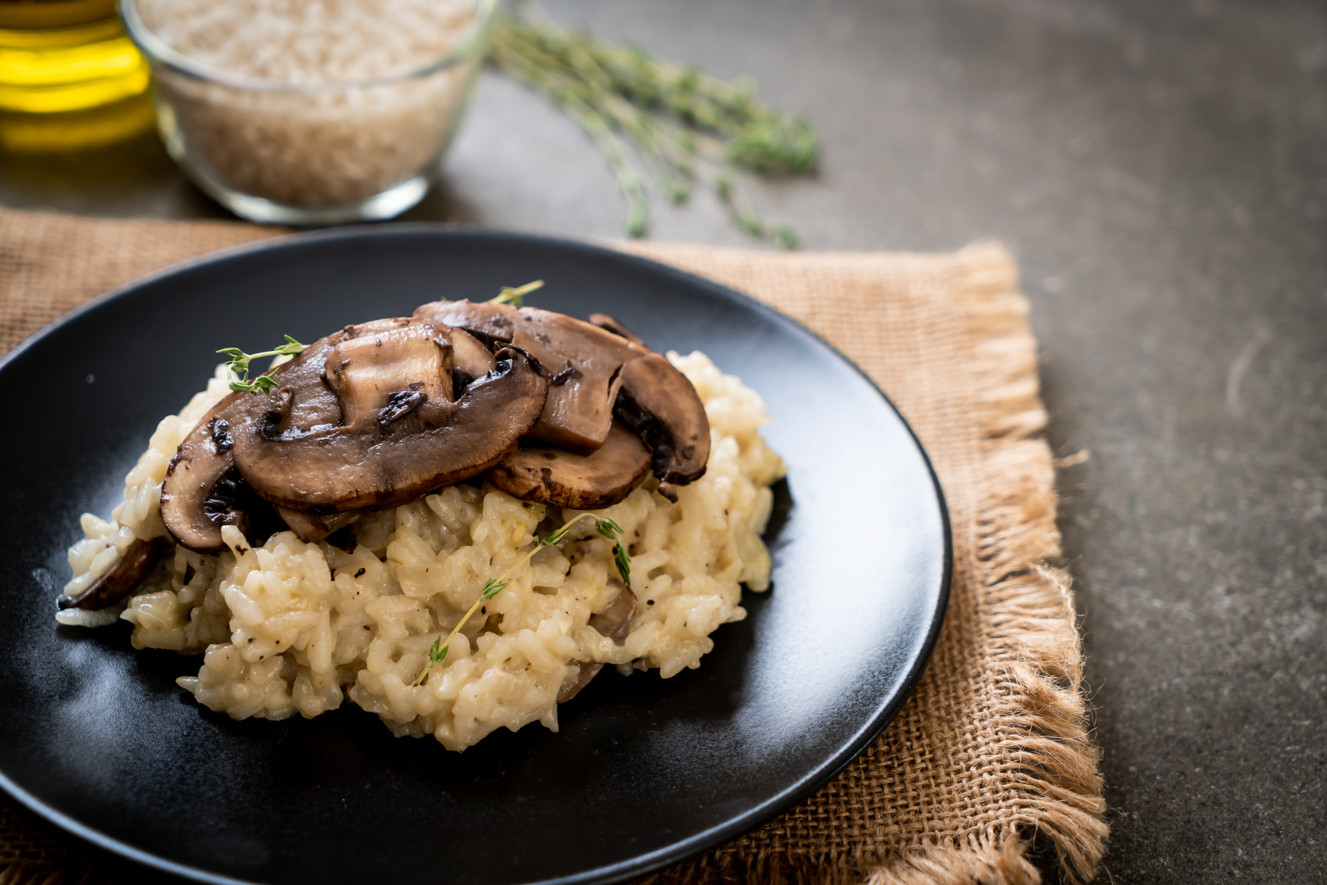 Overhead flat-lay of all ingredients for Rich Italian Porcini and Truffle Oil Risotto laid out on a kitchen surface.