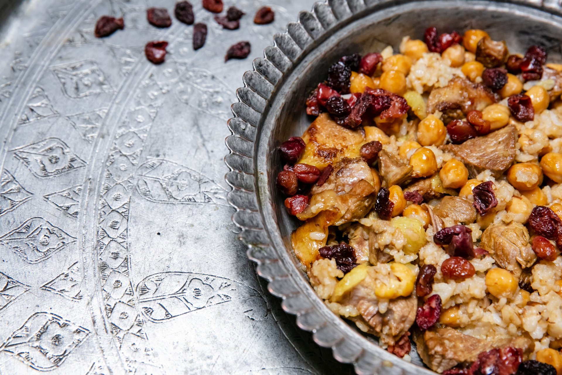 Overhead flat-lay of all ingredients for Rich Moroccan Lamb Couscous with Apricots and Almonds laid out on a kitchen surface.