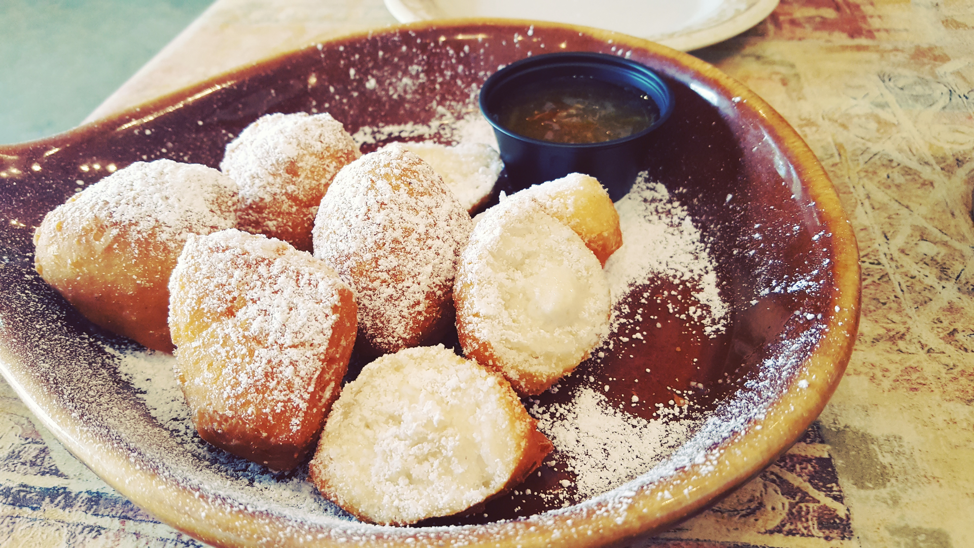 Overhead flat-lay of all ingredients for Rich New Orleans Beignets with Powdered Sugar laid out on a kitchen surface.