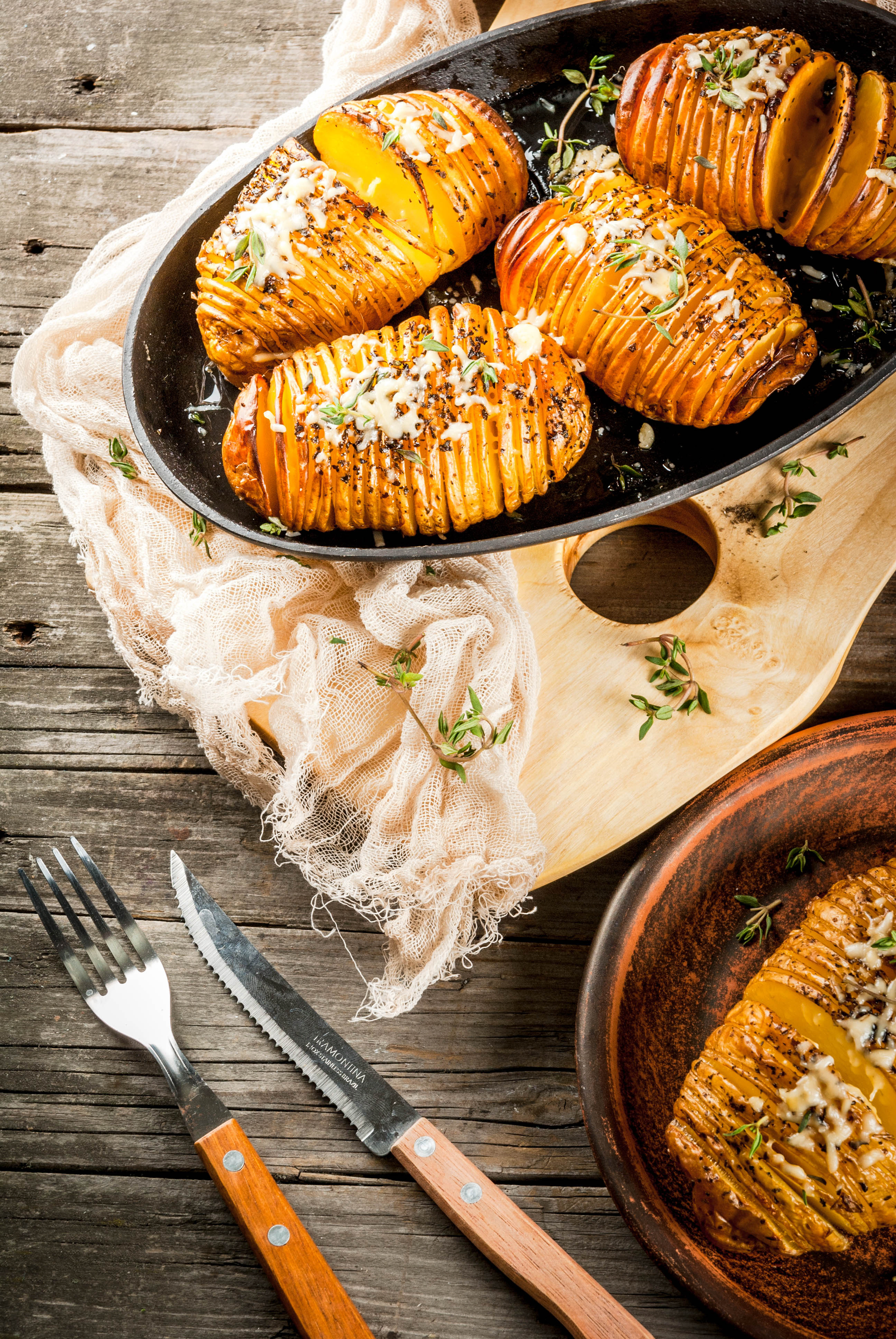 Rich Swedish Hasselback Potatoes with Garlic Butter — Side Dish served and photographed from above