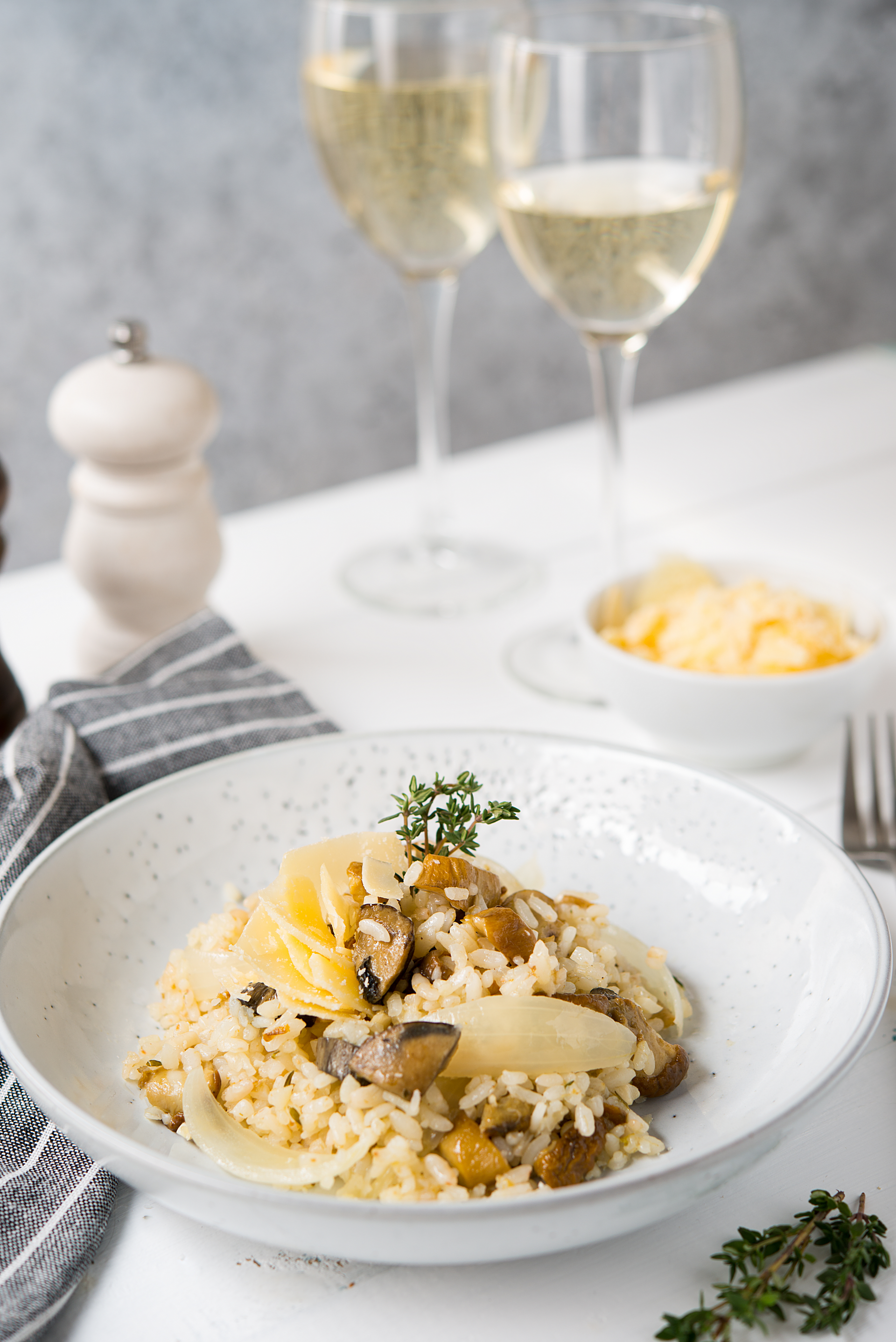 Overhead flat-lay of all ingredients for Risotto ai Funghi laid out on a kitchen surface.
