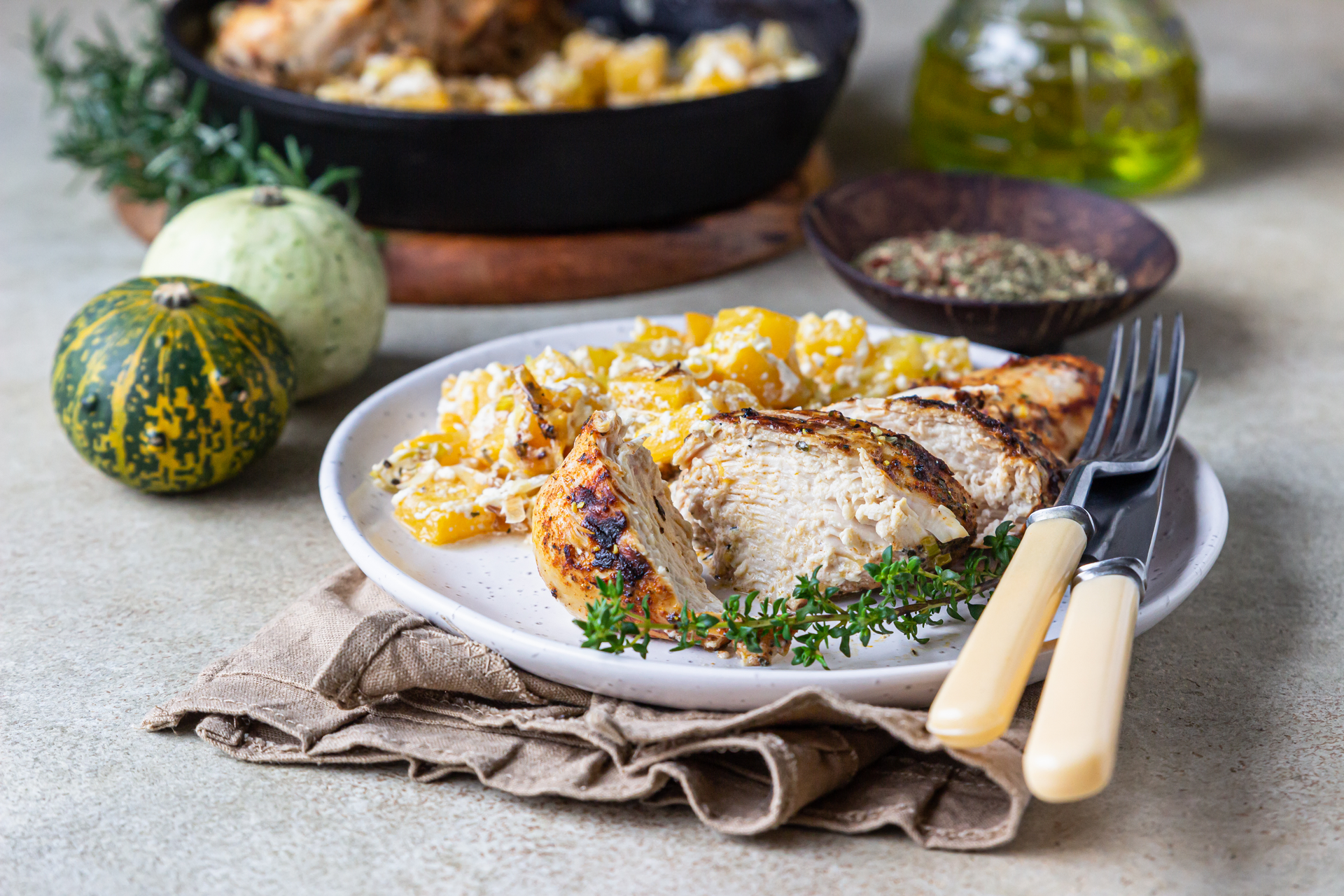 Overhead flat-lay of all ingredients for Roasted Greek Lemon Chicken with Orzo laid out on a kitchen surface.