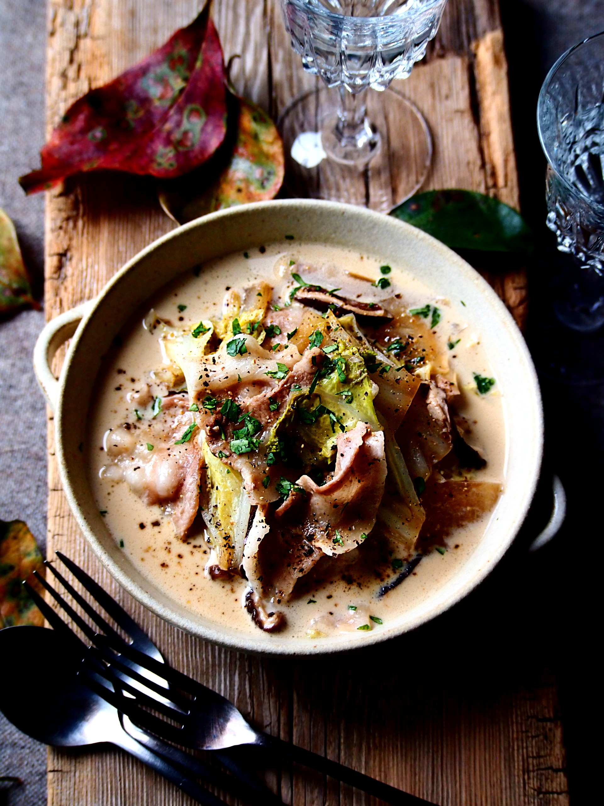 Overhead flat-lay of all ingredients for Robust Icelandic Lamb Soup with Mushrooms and Barley laid out on a kitchen surface.