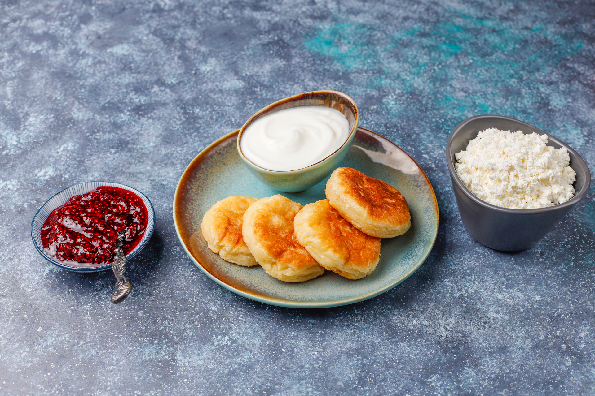 Russian Oladi with Sour Cream and Jam — Breakfast served and photographed from above
