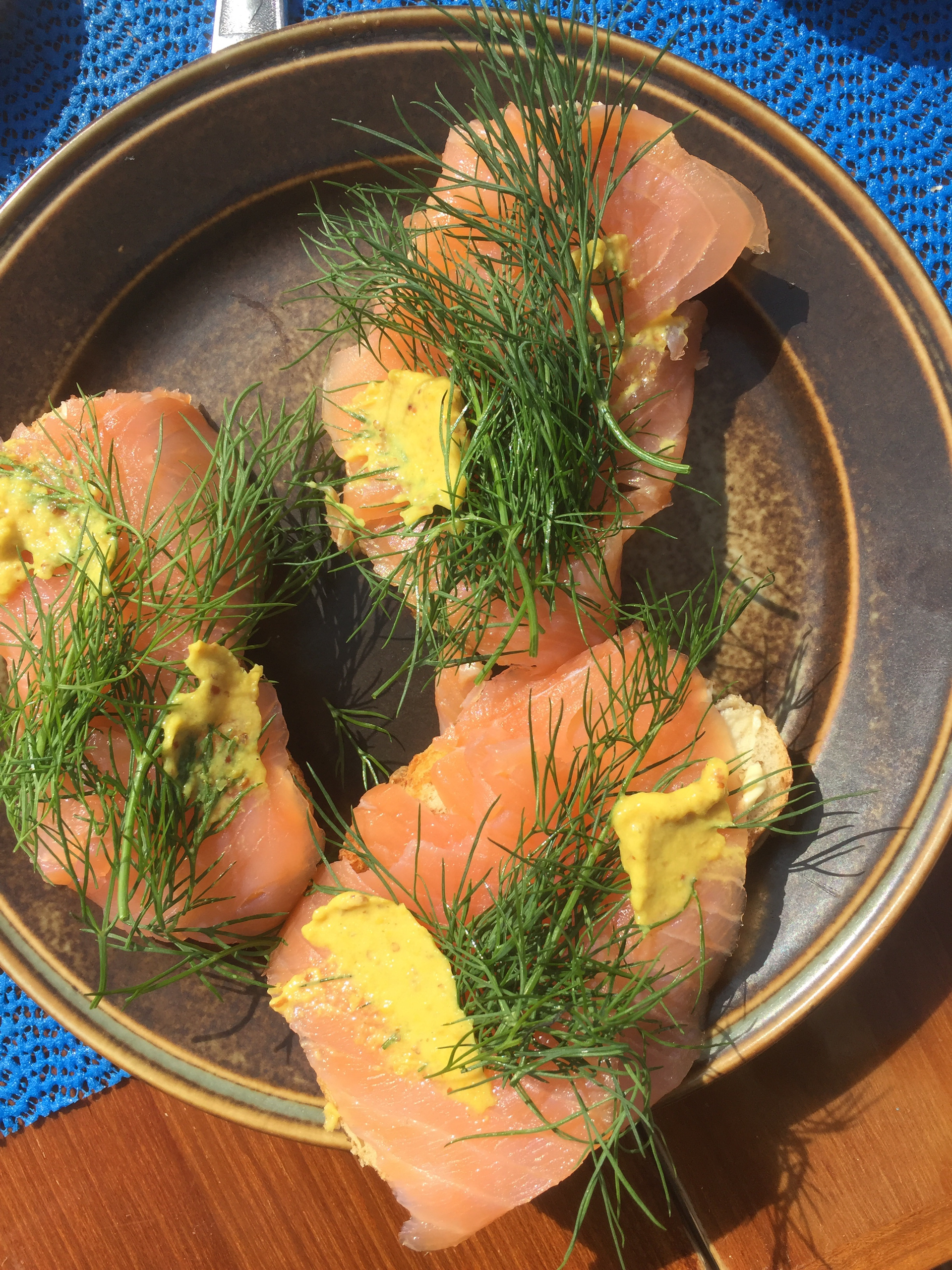 Overhead flat-lay of all ingredients for Rustic Alaskan Salmon en Papillote with Dill and Lemon laid out on a kitchen surface.