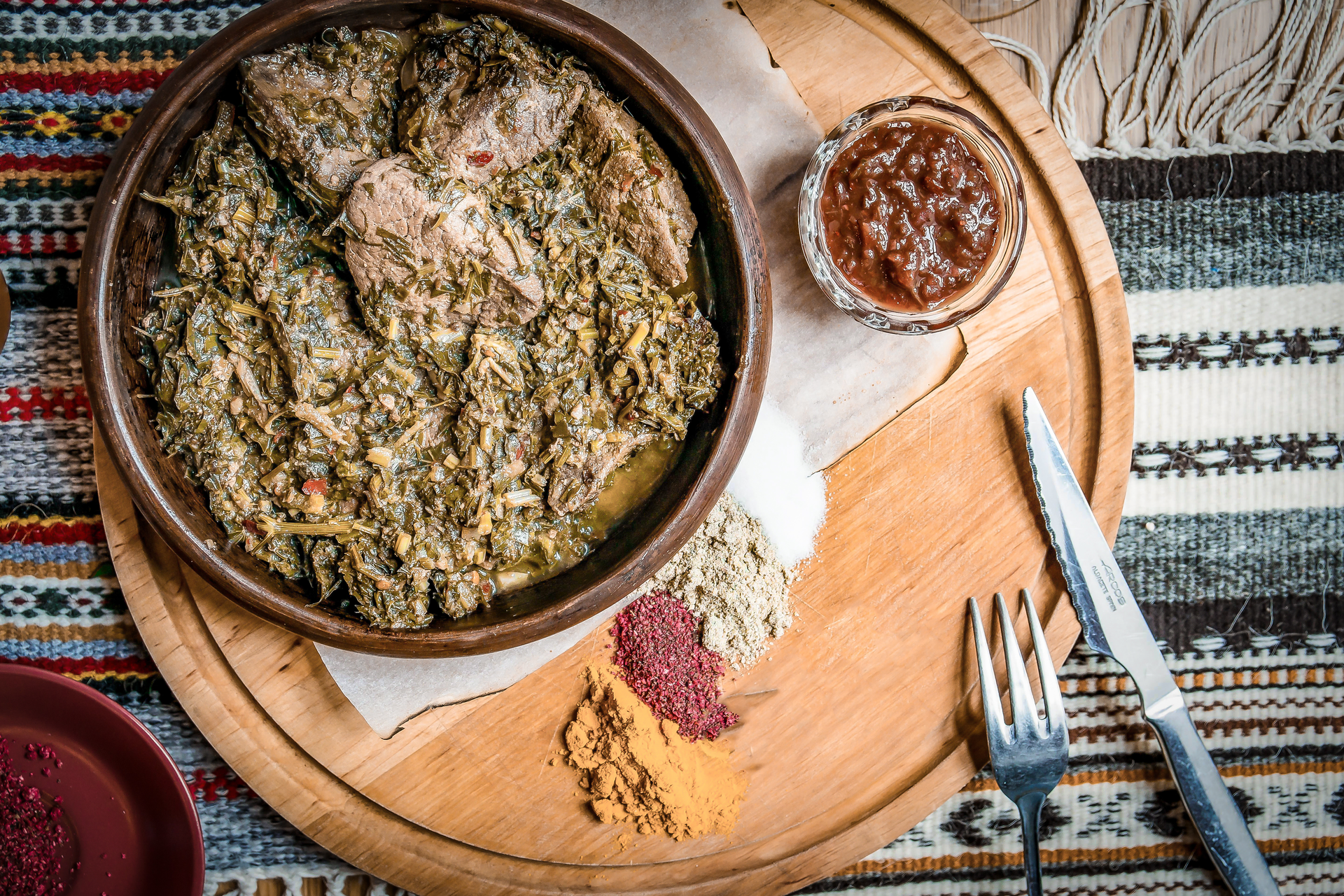 Overhead flat-lay of all ingredients for Rustic Algerian Berkoukes with Harissa and Lamb laid out on a kitchen surface.