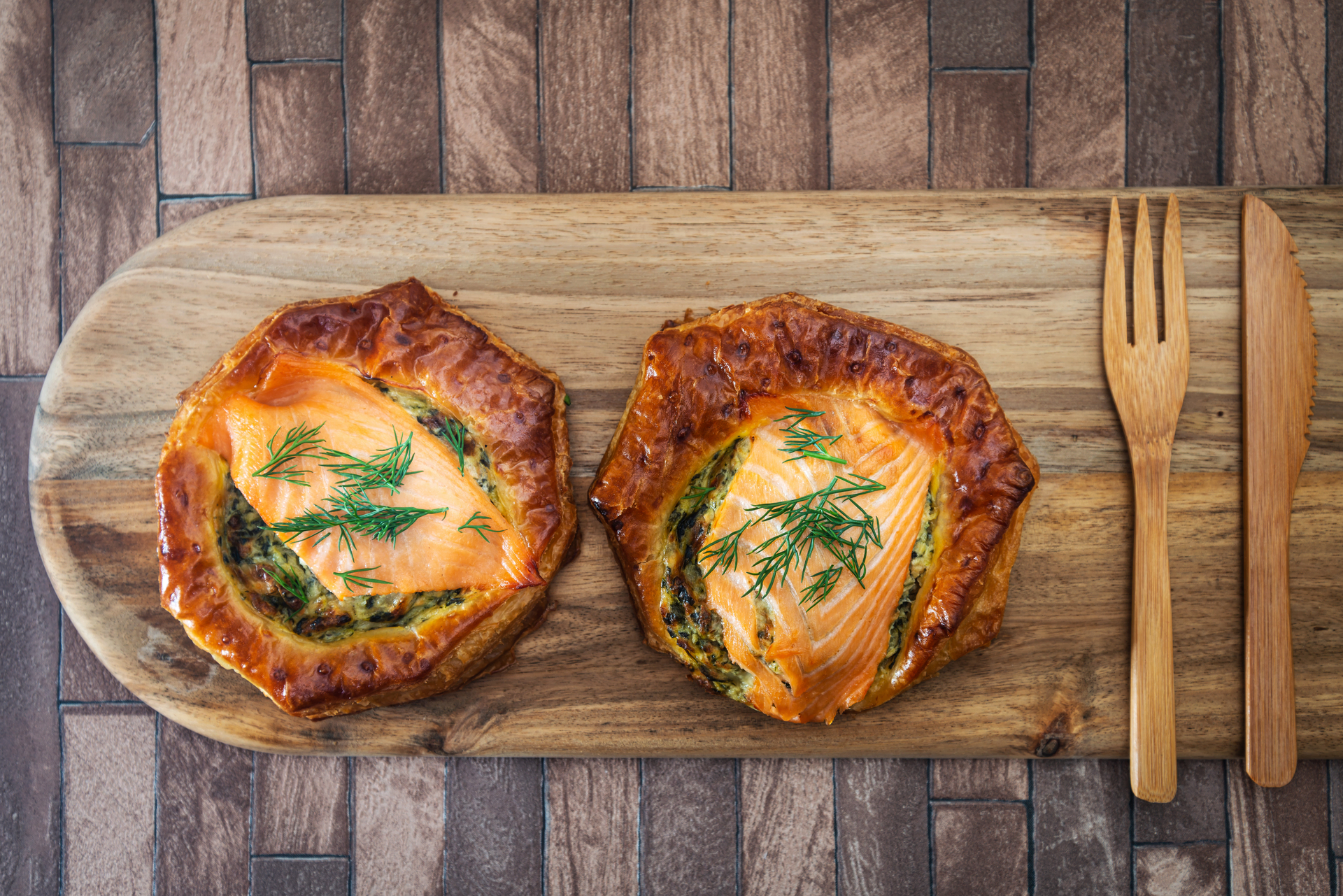 Overhead flat-lay of all ingredients for Rustic Finnish Salmon Pie with Dill and Leeks laid out on a kitchen surface.