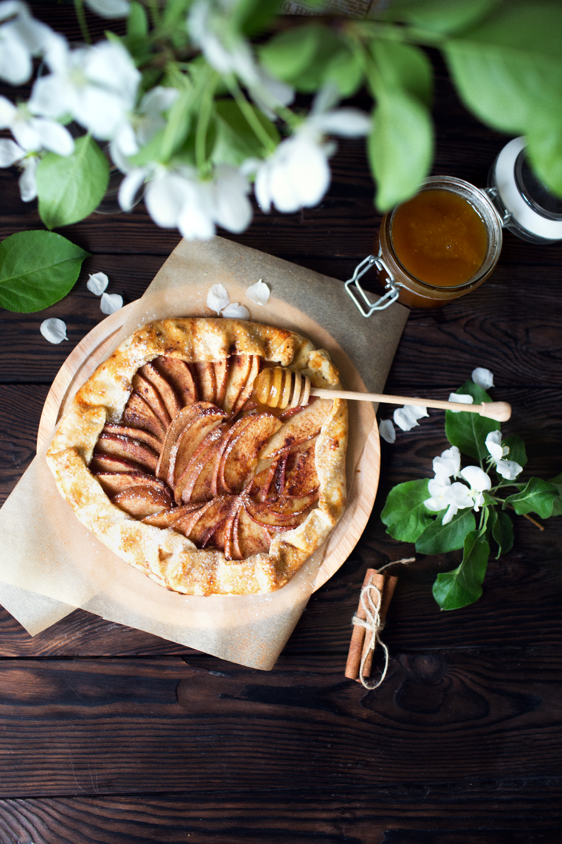 Overhead flat-lay of all ingredients for Rustic French Apple Tart with Lavender Honey Drizzle laid out on a kitchen surface.