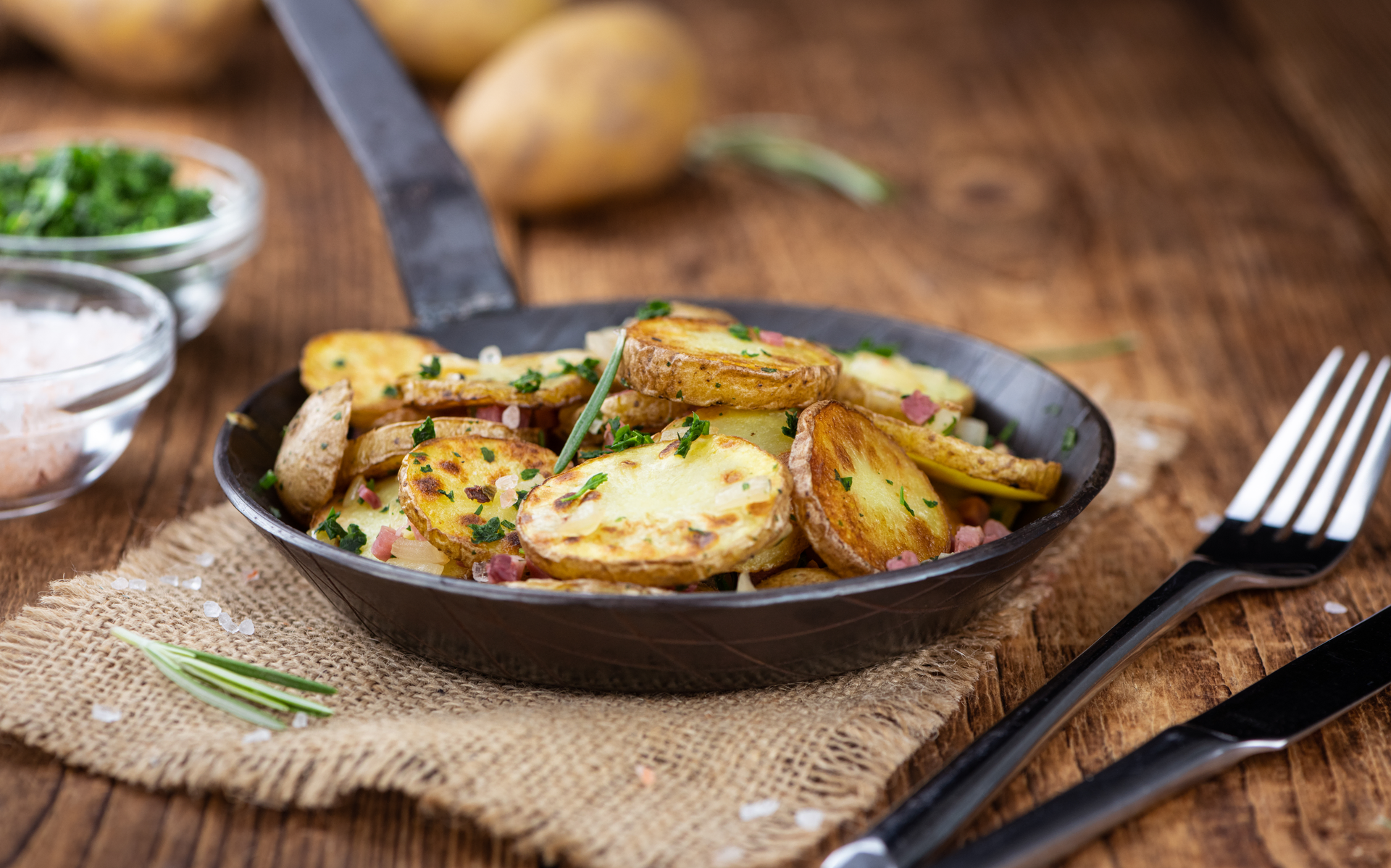Overhead flat-lay of all ingredients for Rustic French Potato Gratin with Gruyère and Thyme laid out on a kitchen surface.