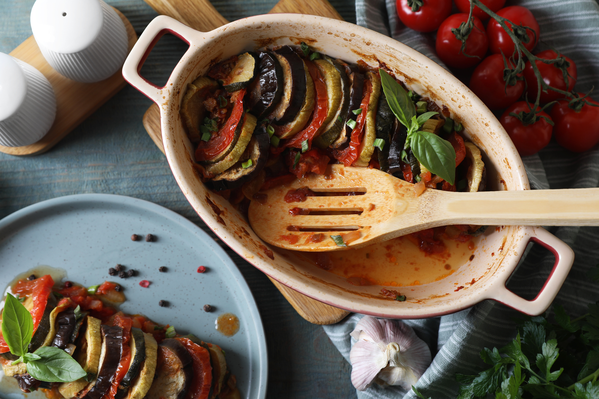Overhead flat-lay of all ingredients for Rustic French Ratatouille with Heirloom Tomatoes laid out on a kitchen surface.