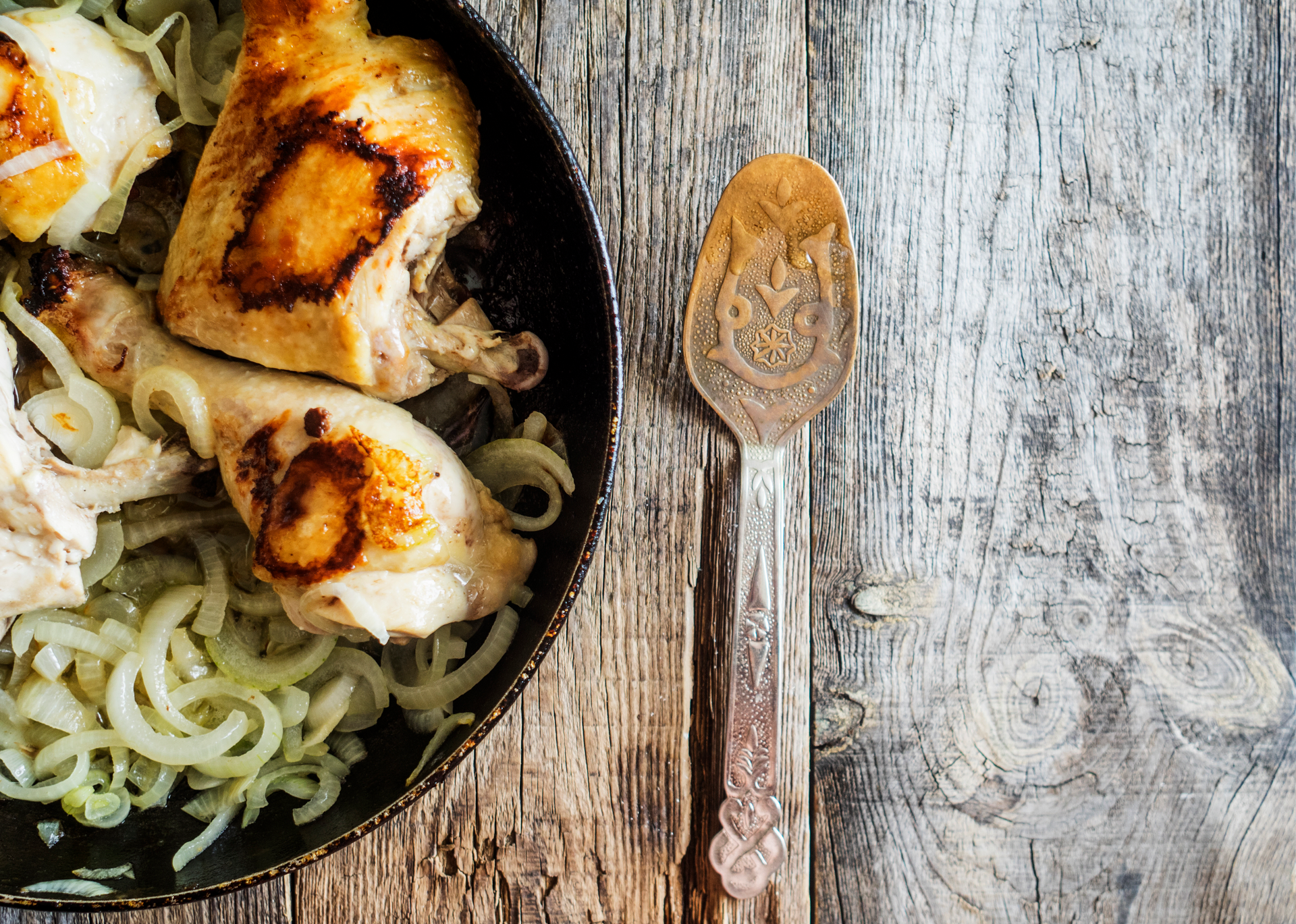 Overhead flat-lay of all ingredients for Rustic French Tarragon Chicken with Cider Sauce laid out on a kitchen surface.