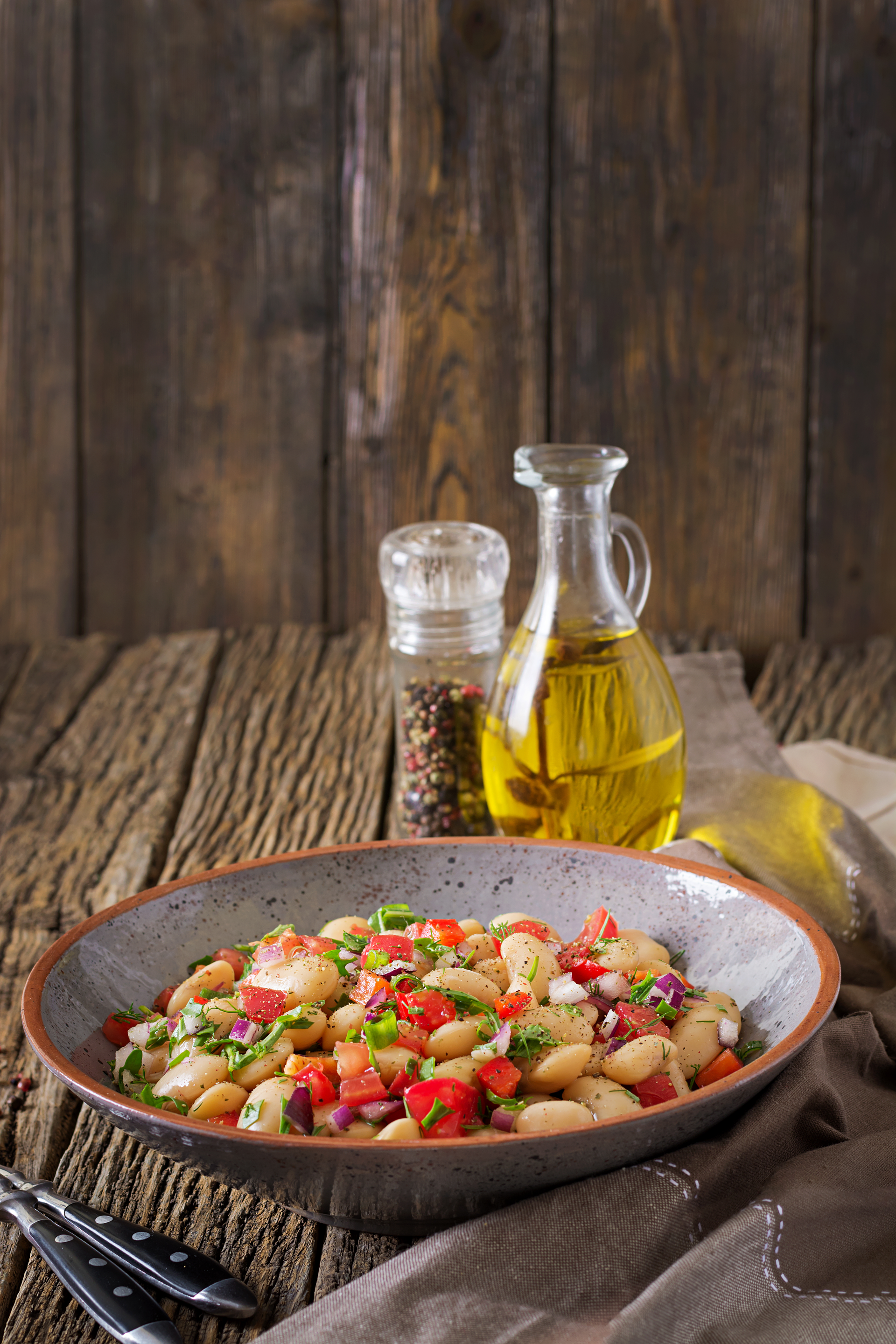 Overhead flat-lay of all ingredients for Rustic Greek Fasolakia with Tomato and Olive Oil laid out on a kitchen surface.