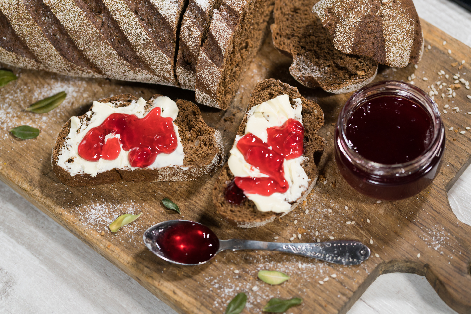 Overhead flat-lay of all ingredients for Rustic Irish Brown Bread with Butter and Jam laid out on a kitchen surface.