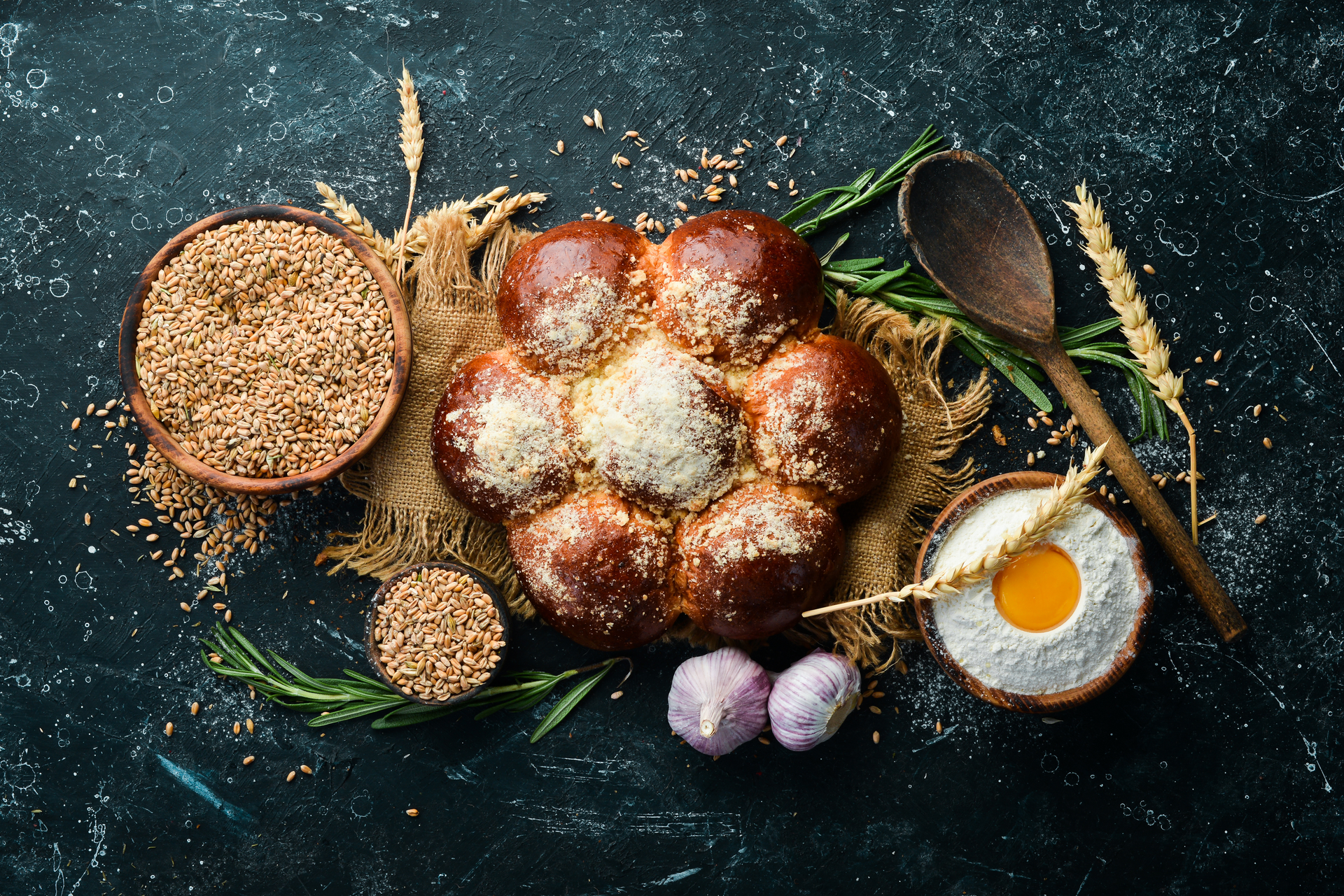 Overhead flat-lay of all ingredients for Rustic Polish Żurek with Sourdough and Sausages laid out on a kitchen surface.