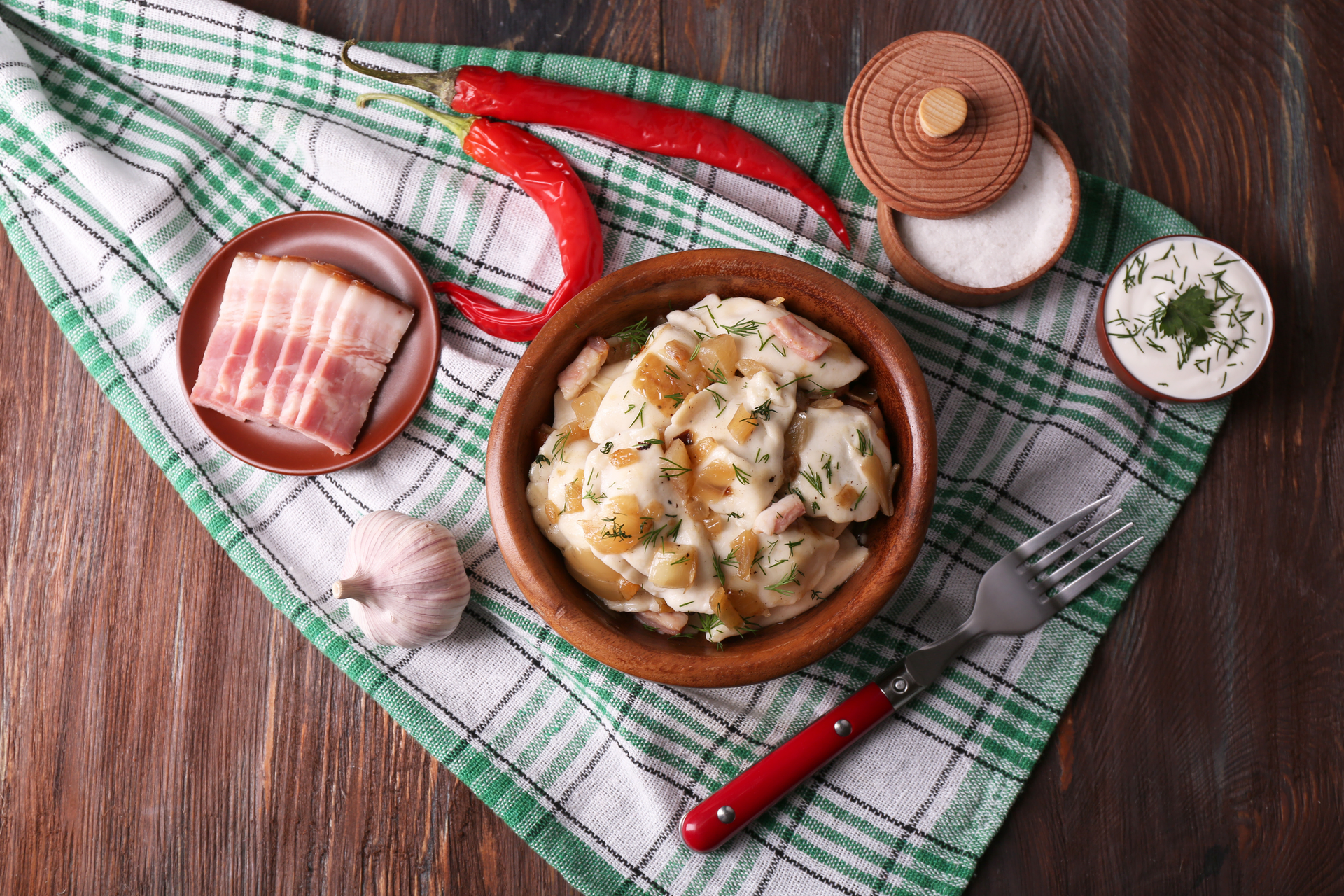Overhead flat-lay of all ingredients for Rustic Slovakian Bryndzové Halušky with Bacon and Chives laid out on a kitchen surface.