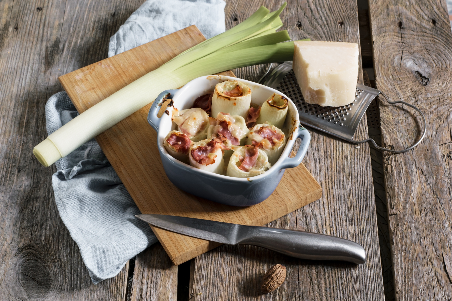 Overhead flat-lay of all ingredients for Rustic Spanish Escudella i Carn d'Olla with Artichokes and Sausage laid out on a kitchen surface.