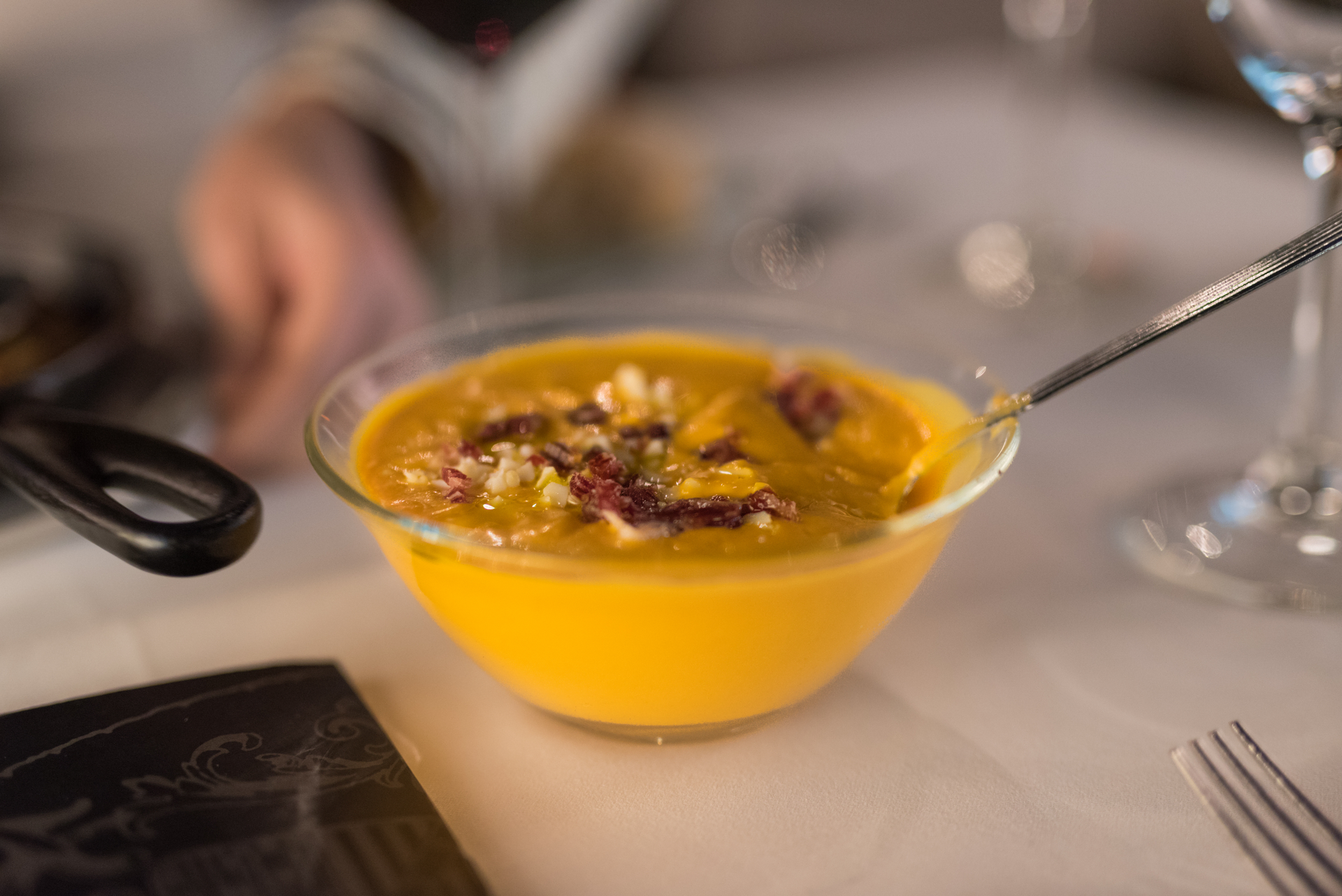 Overhead flat-lay of all ingredients for Saffron-Infused Catalan Escudella with Pork and Chickpeas laid out on a kitchen surface.