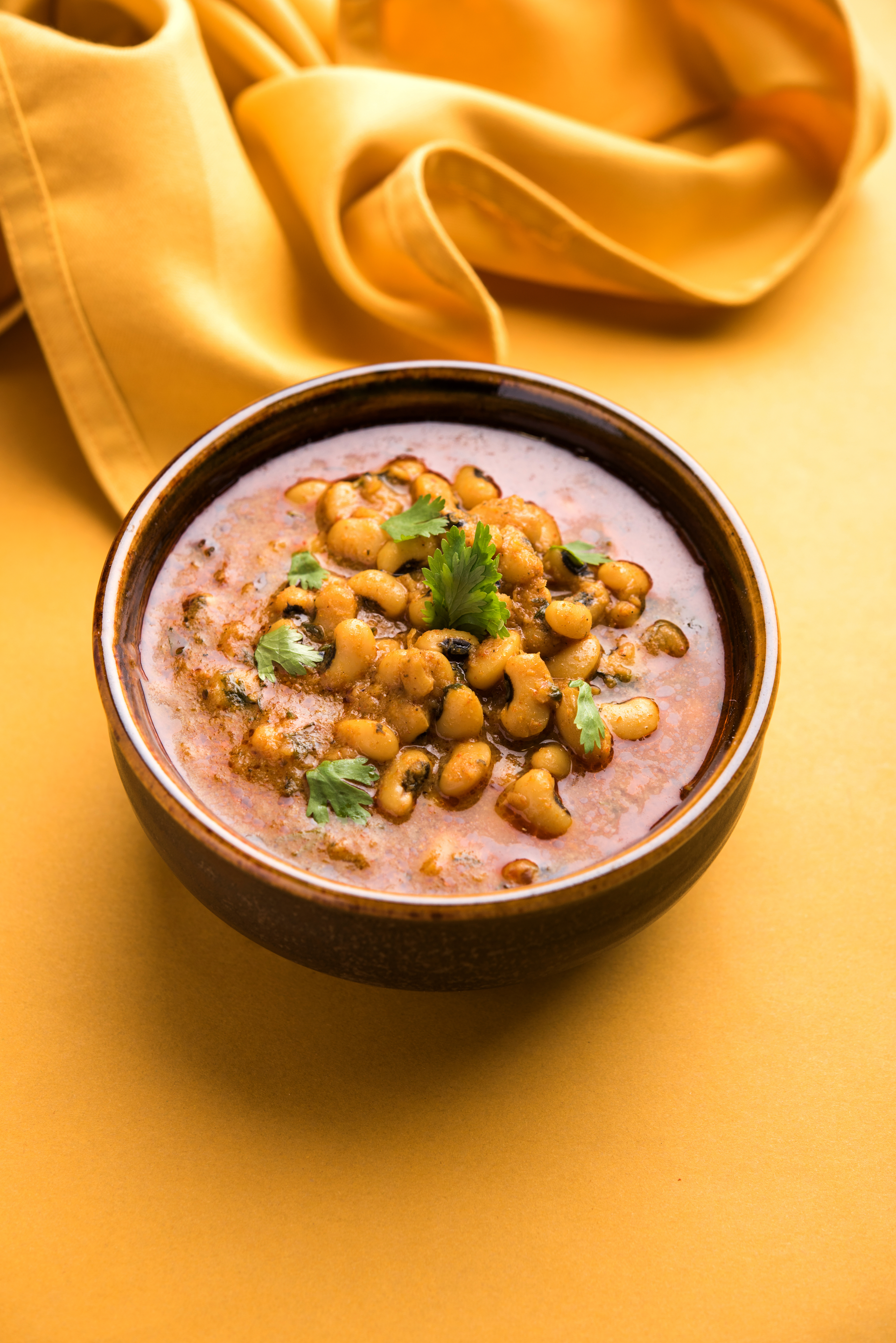 Overhead flat-lay of all ingredients for Saffron-Infused Indian Rajma Curry with Coconut Cream laid out on a kitchen surface.