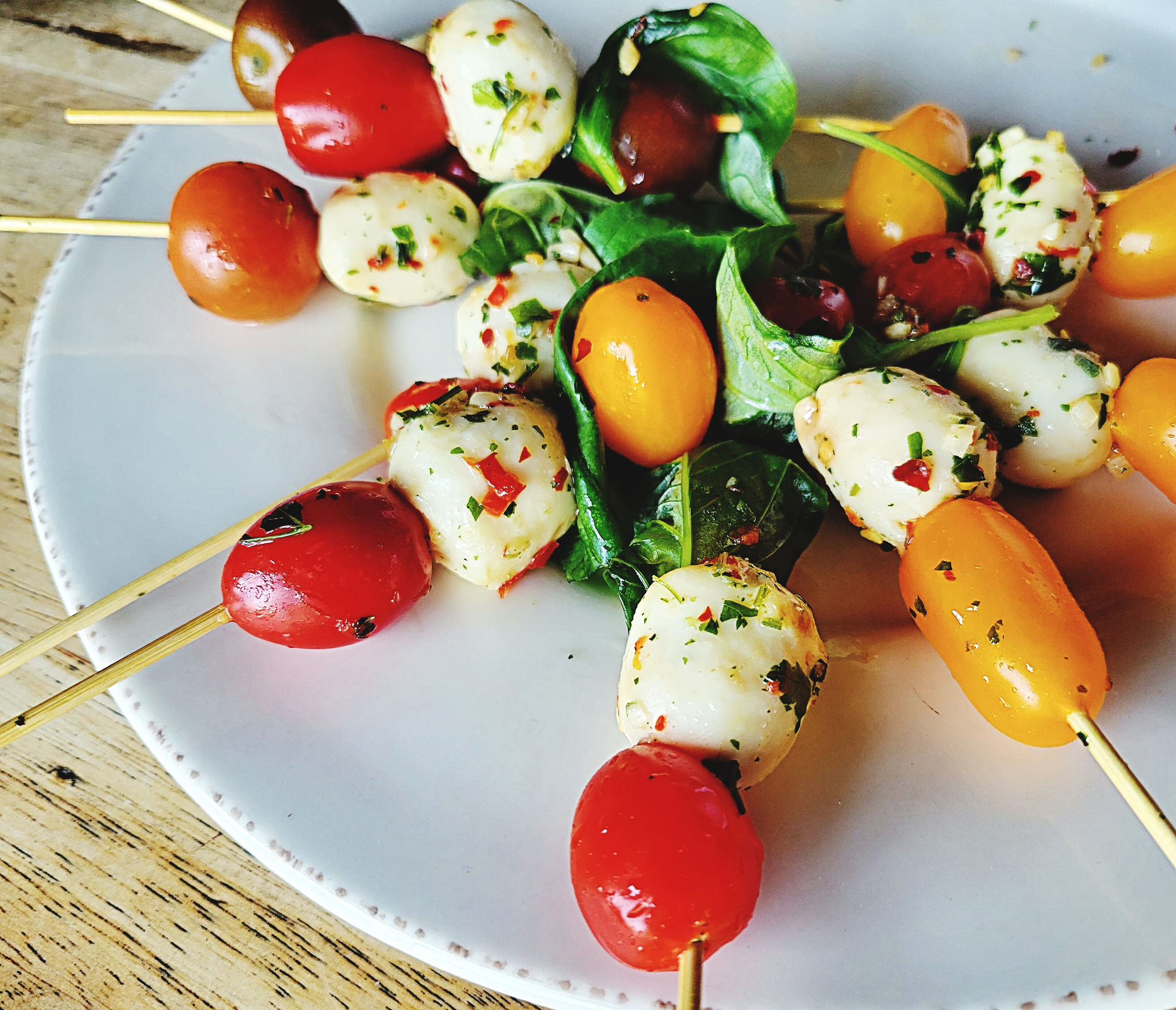 Overhead flat-lay of all ingredients for Savory Basque Pintxos with Gilda Anchovy Skewers laid out on a kitchen surface.