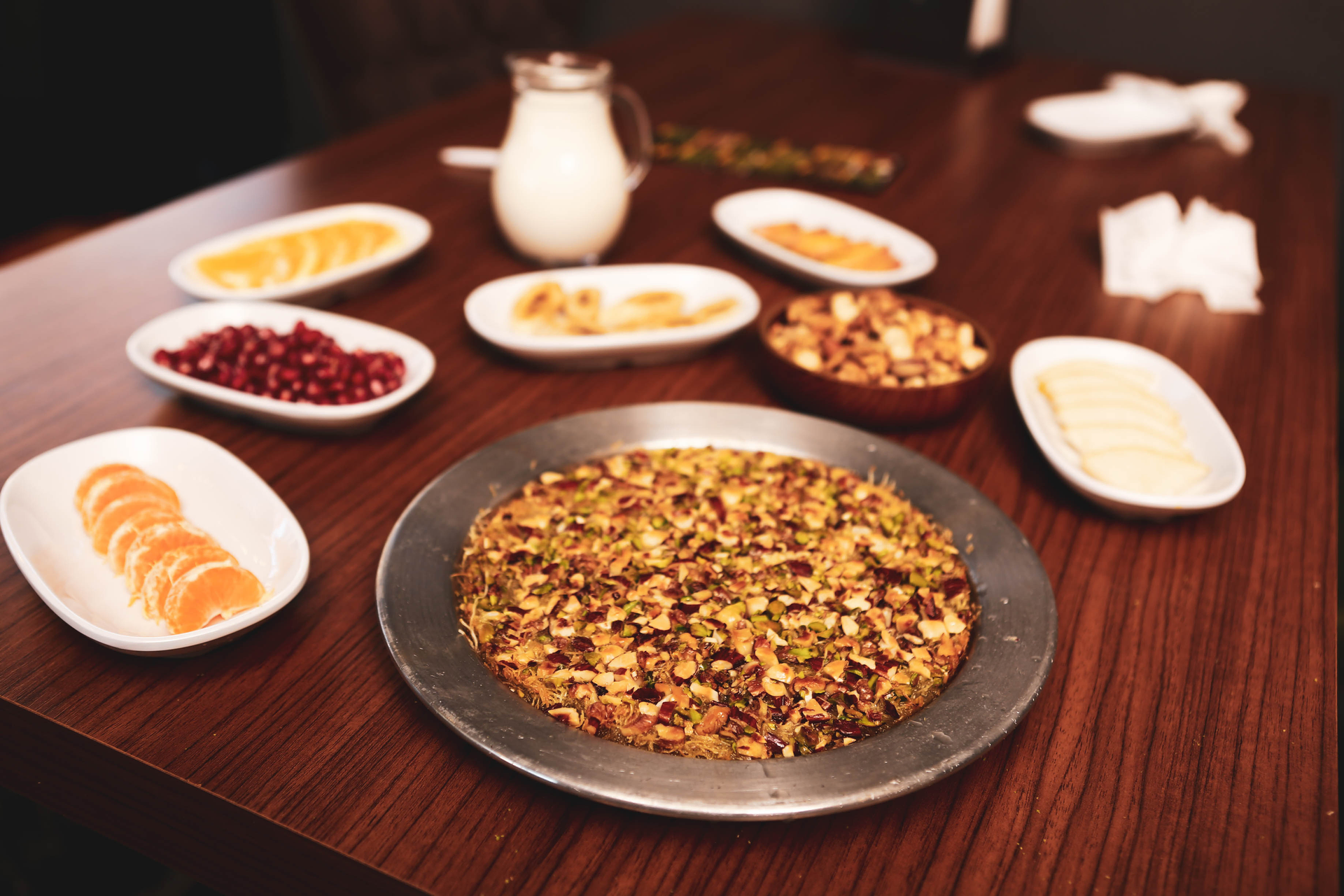 Overhead flat-lay of all ingredients for Savory Bhutanese Red Rice Salad with Roasted Pumpkin and Toasted Nuts laid out on a kitchen surface.