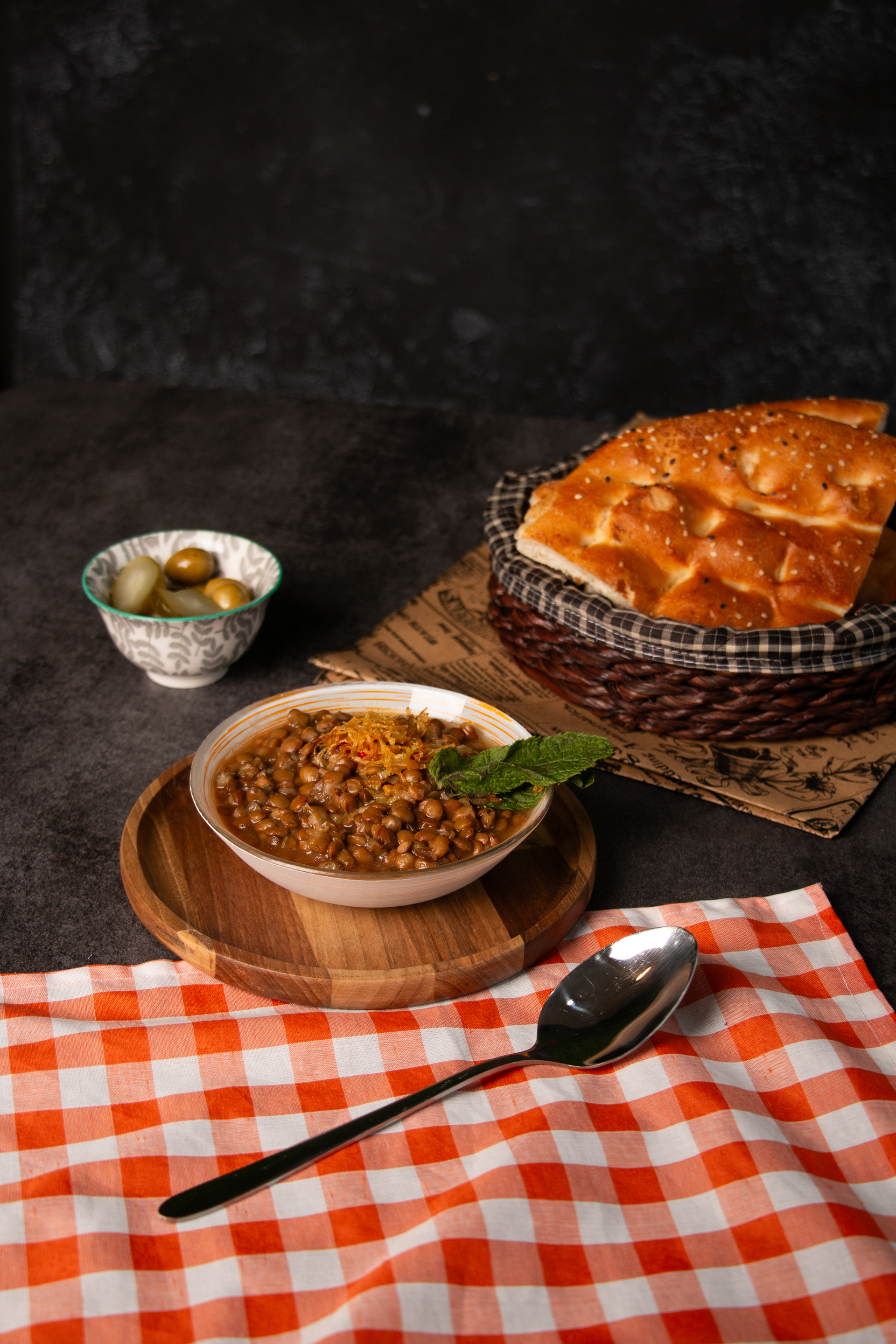 Overhead flat-lay of all ingredients for Savory Egyptian Koshari Pie with Lentil and Tomato Layers laid out on a kitchen surface.
