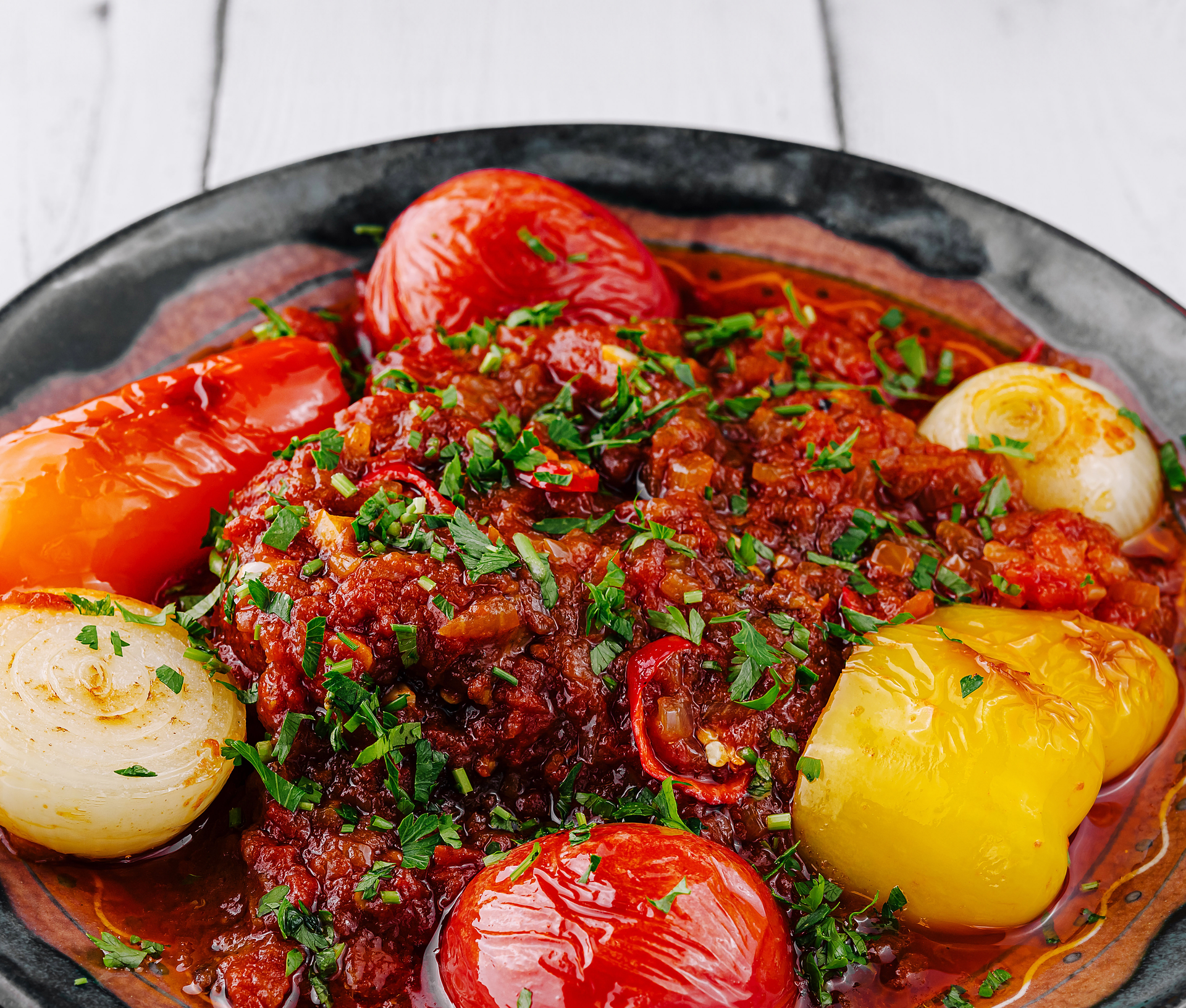 Overhead flat-lay of all ingredients for Savory Eritrean Zigni with Spicy Tomato Stew laid out on a kitchen surface.