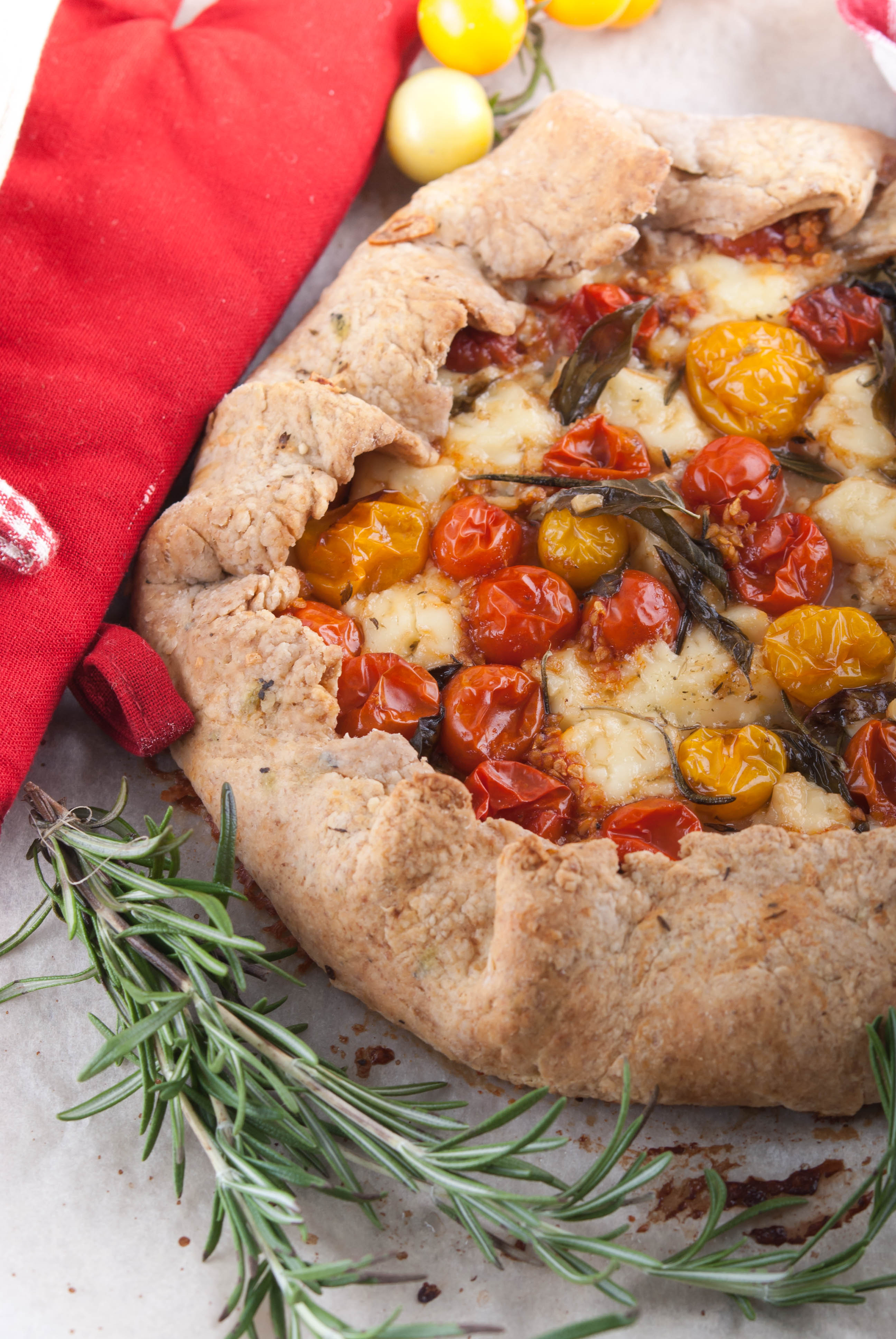 Overhead flat-lay of all ingredients for Savory Florentine Herb-Infused Focaccia with Sun-Dried Tomato Relish laid out on a kitchen surface.