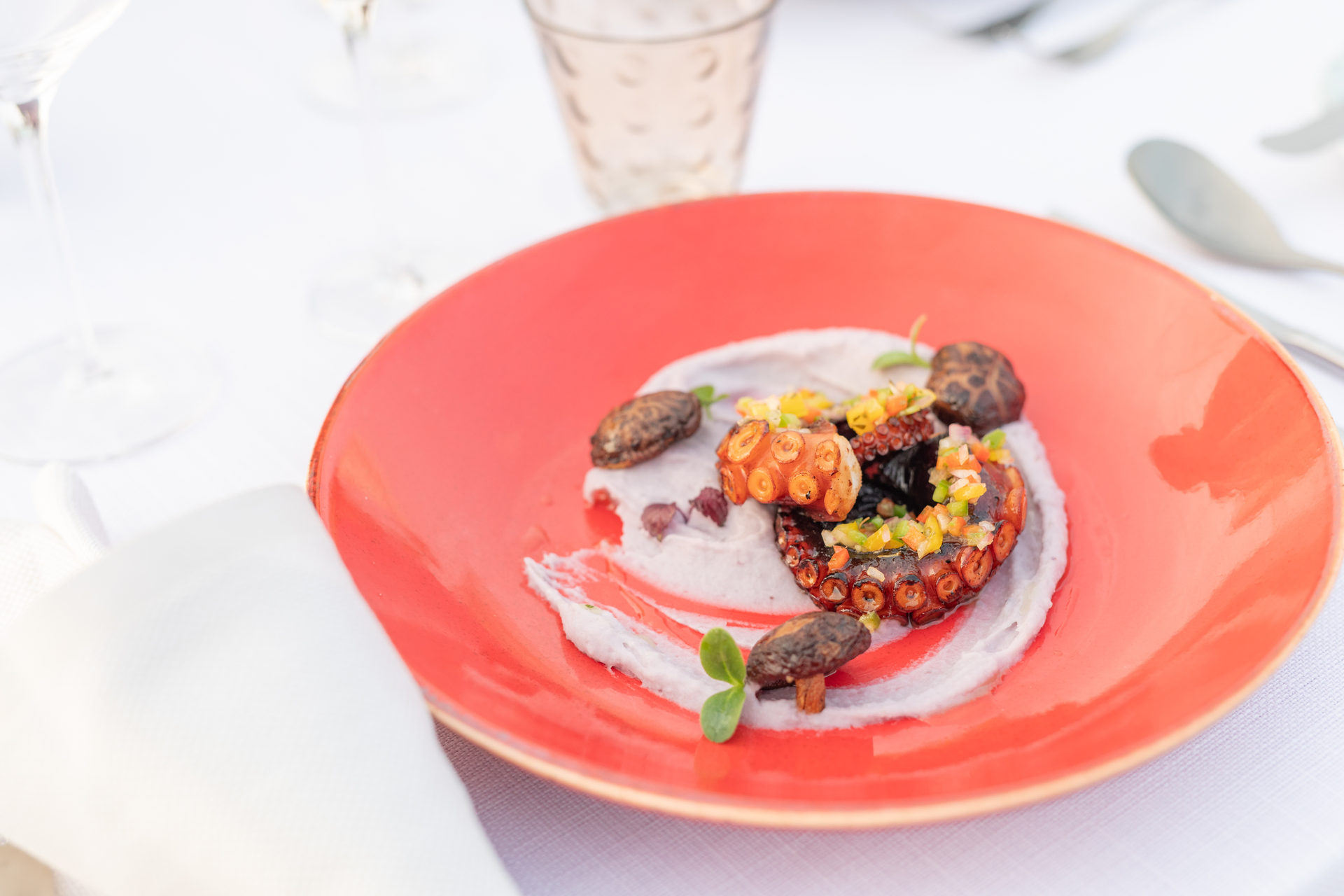 Overhead flat-lay of all ingredients for Savory Galician Octopus with Smoked Paprika laid out on a kitchen surface.