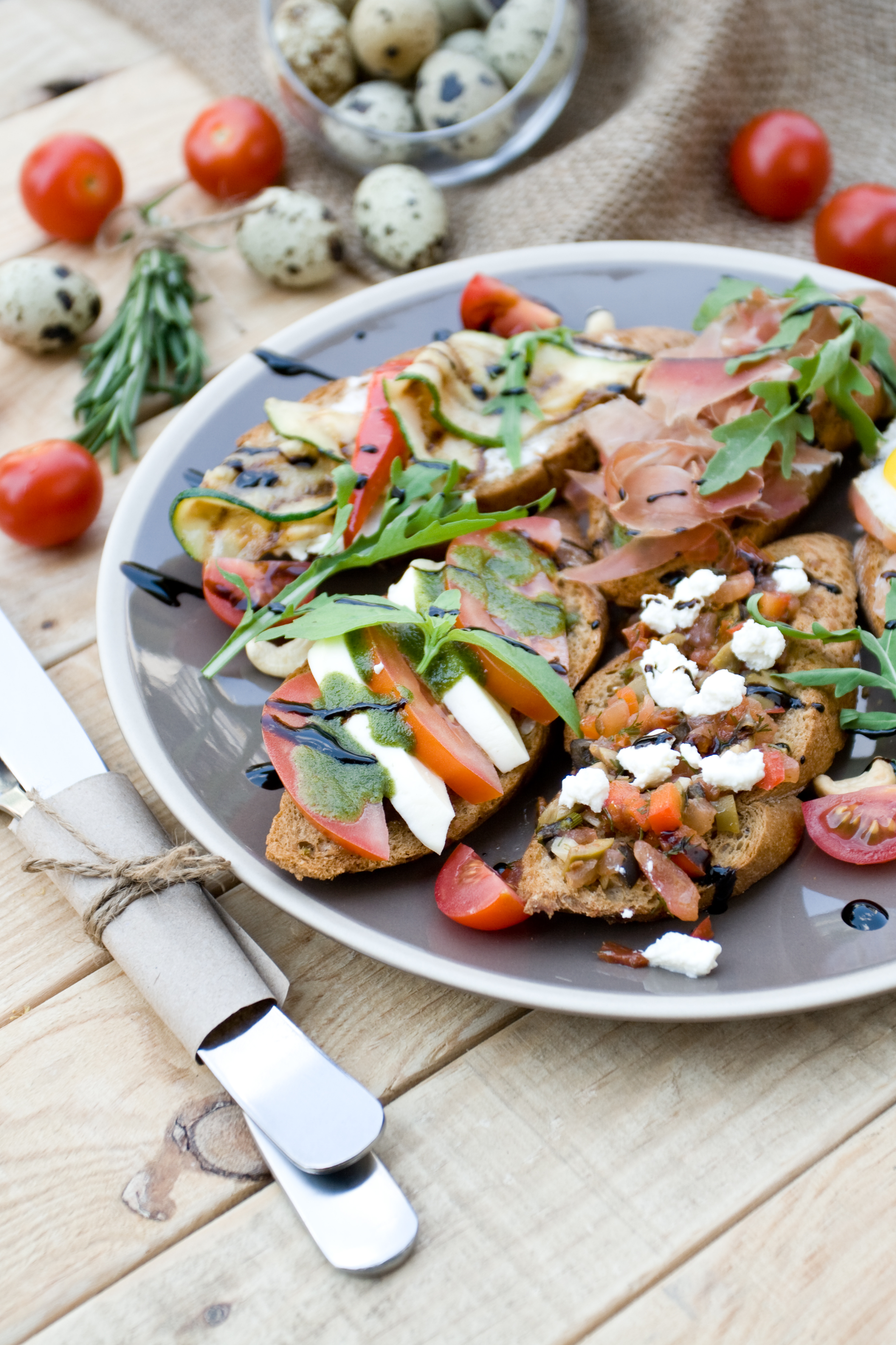 Overhead flat-lay of all ingredients for Savory Greek Dakos with Feta and Tomatoes laid out on a kitchen surface.