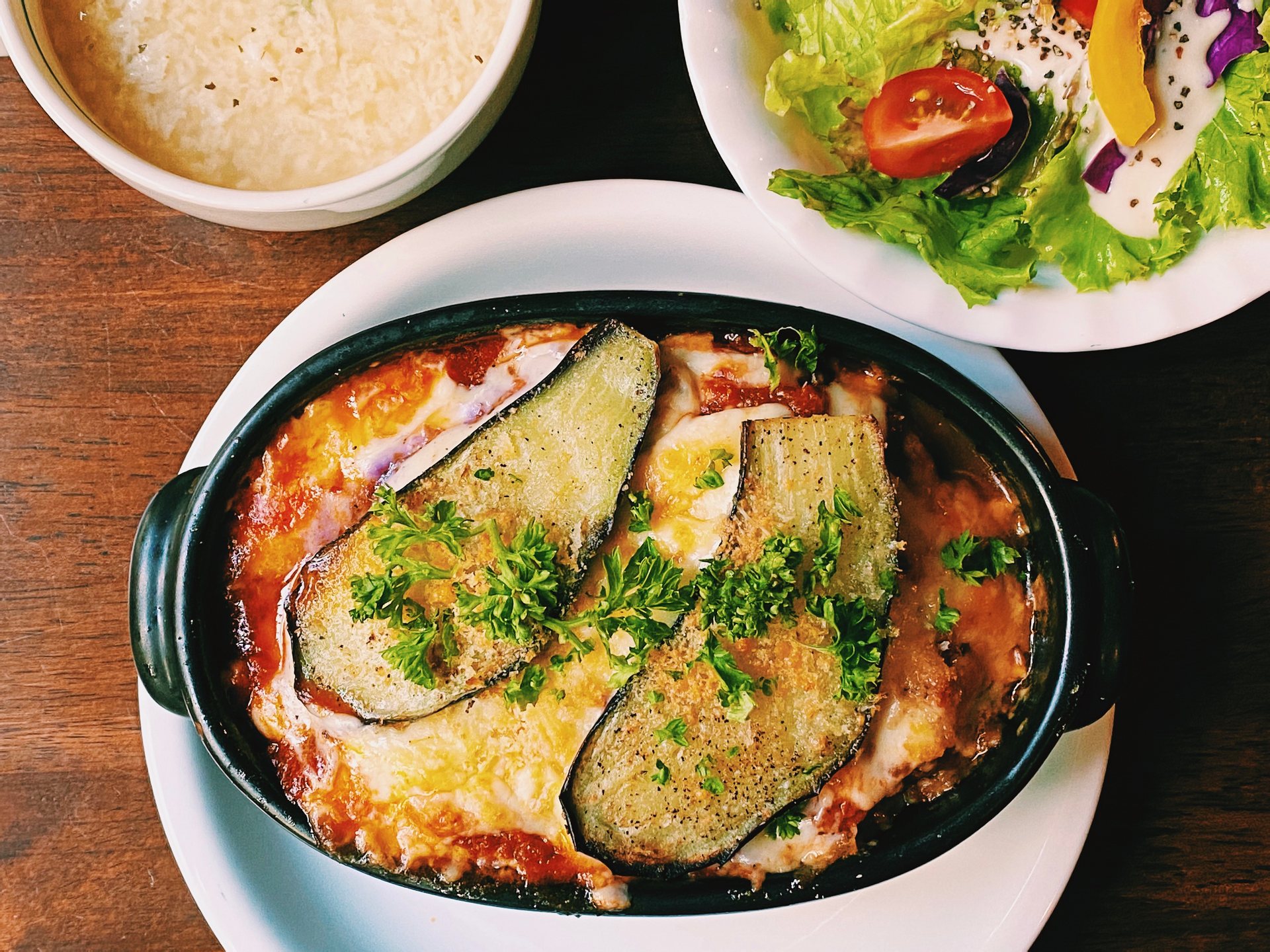 Savory Greek Moussaka with Fresh Mint and Béchamel Sauce — Main Course served and photographed from above