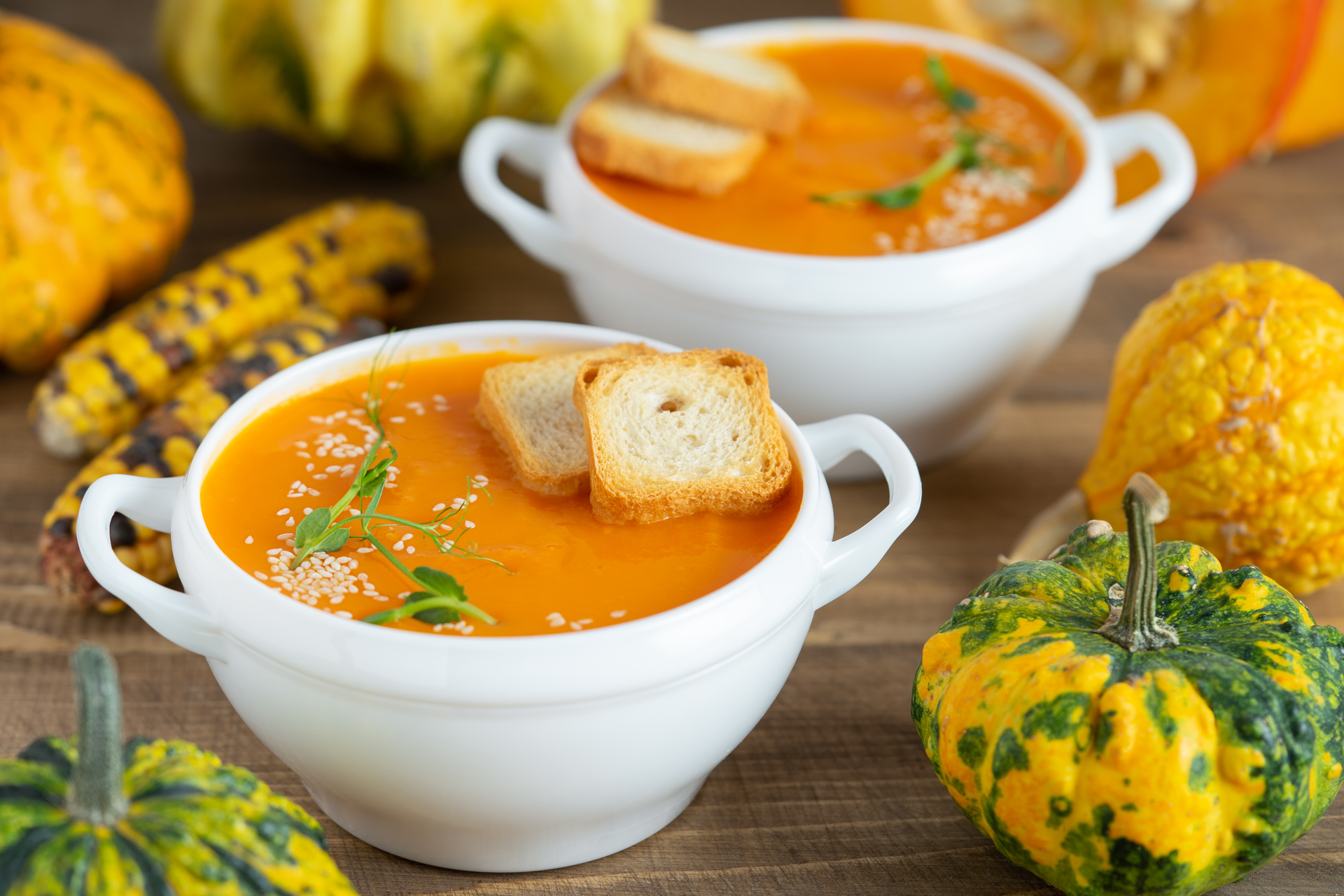 Overhead flat-lay of all ingredients for Savory Haitian Joumou Pumpkin Soup with Orange Essence laid out on a kitchen surface.