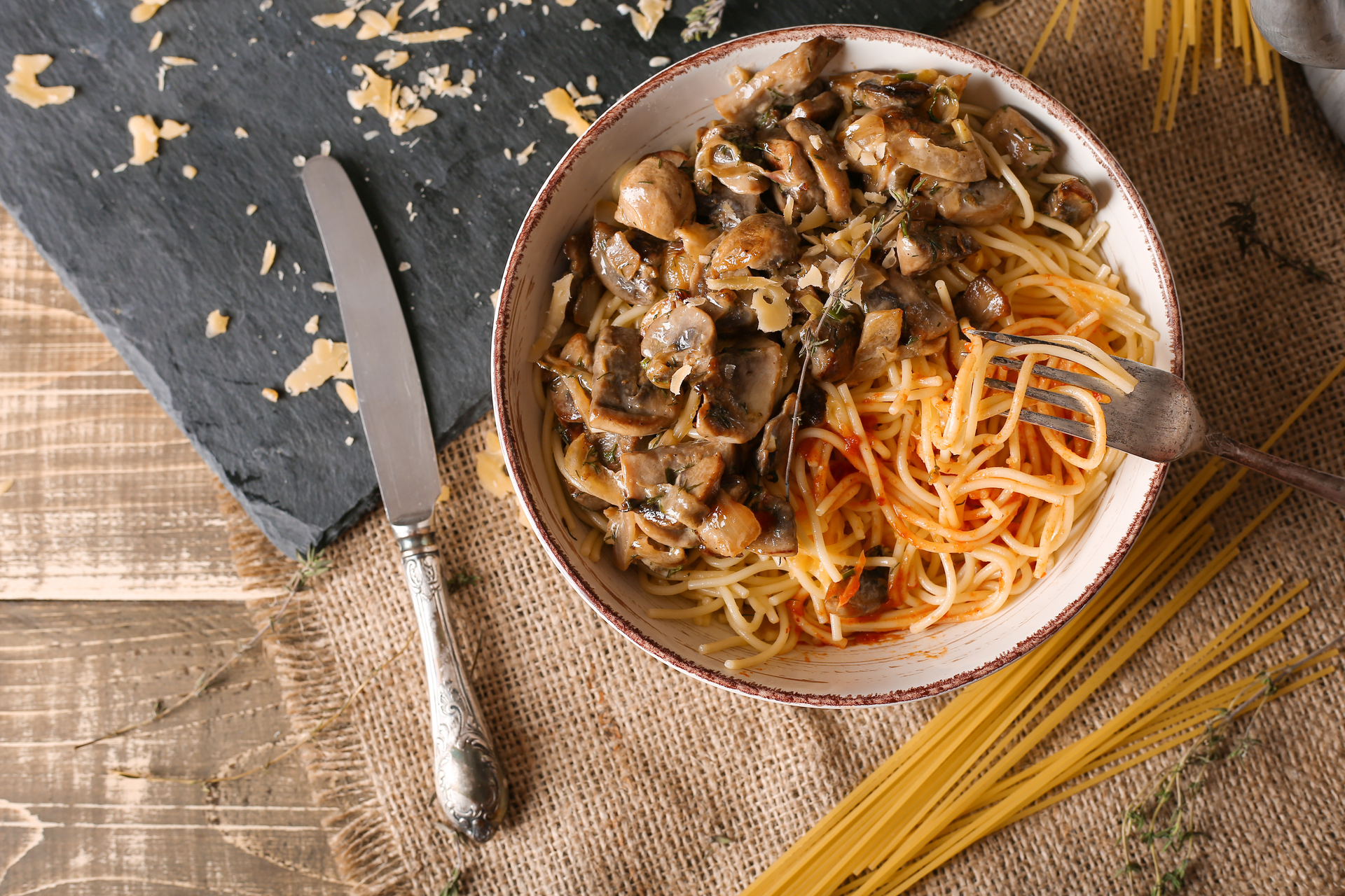 Overhead flat-lay of all ingredients for Savory Hungarian Mushroom Paprikash with Noodles laid out on a kitchen surface.