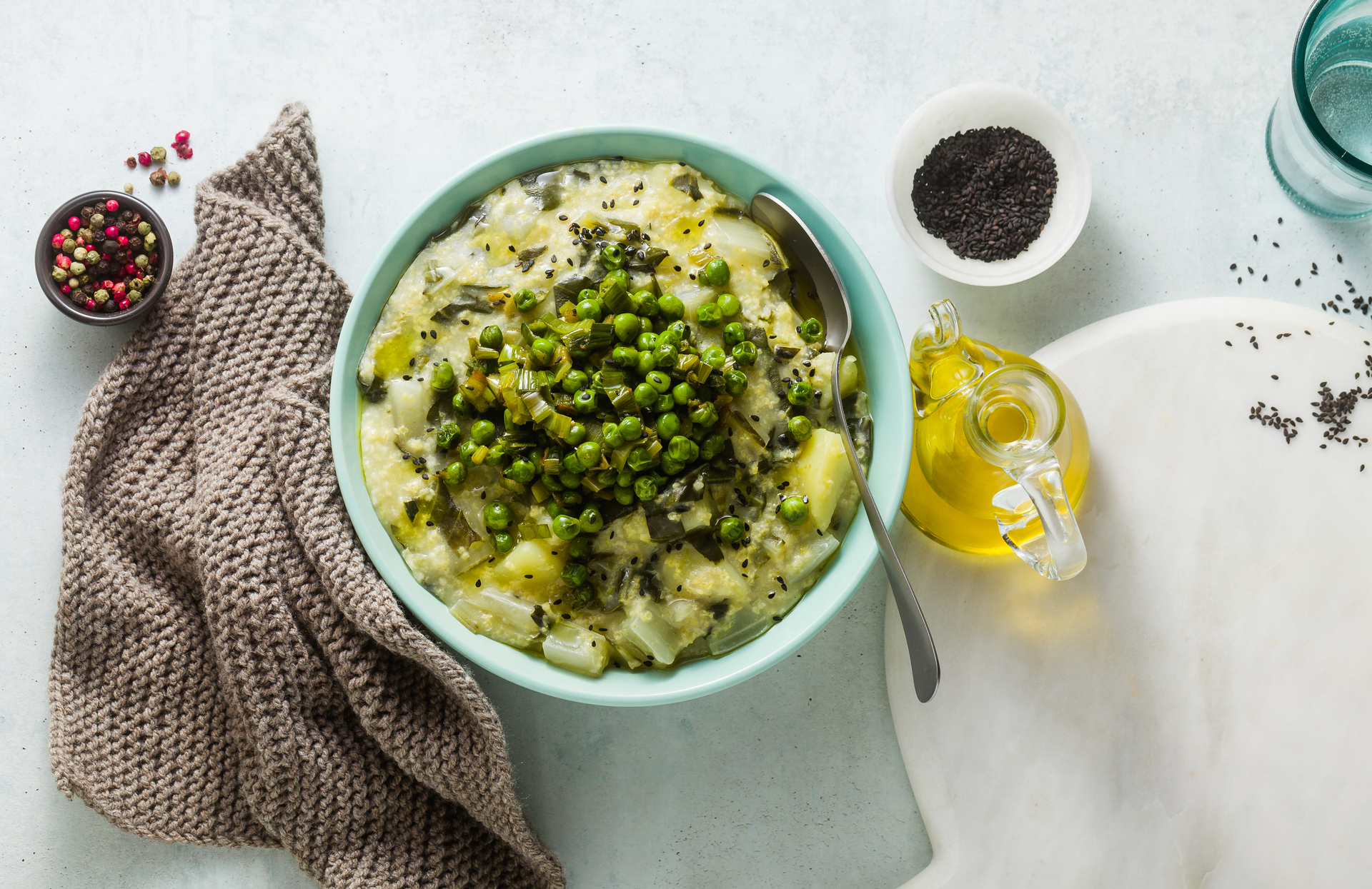 Overhead flat-lay of all ingredients for Savory Icelandic Plokkari with Creamed Peas and Onions laid out on a kitchen surface.