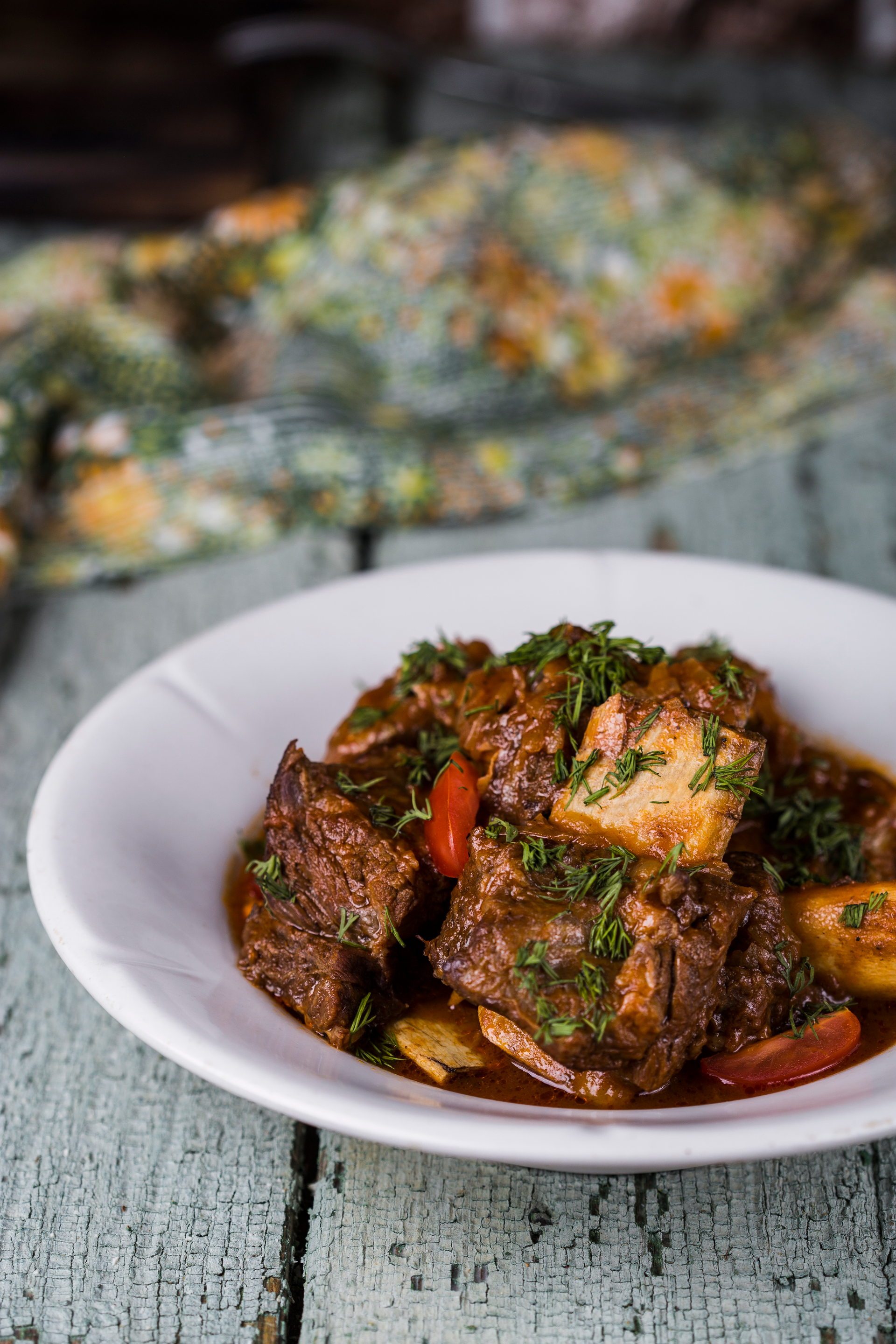 Overhead flat-lay of all ingredients for Savory Jamaican Oxtail Stew laid out on a kitchen surface.