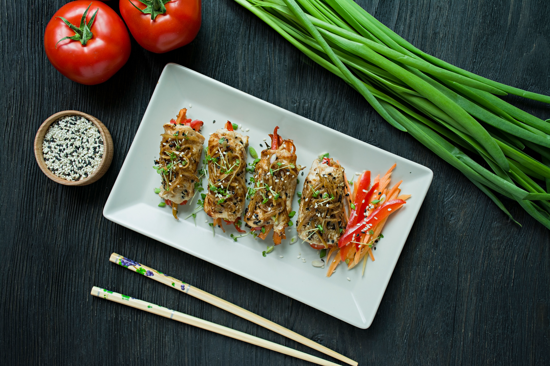Overhead flat-lay of all ingredients for Savory Korean Japchae Spring Rolls with Sesame Dip laid out on a kitchen surface.