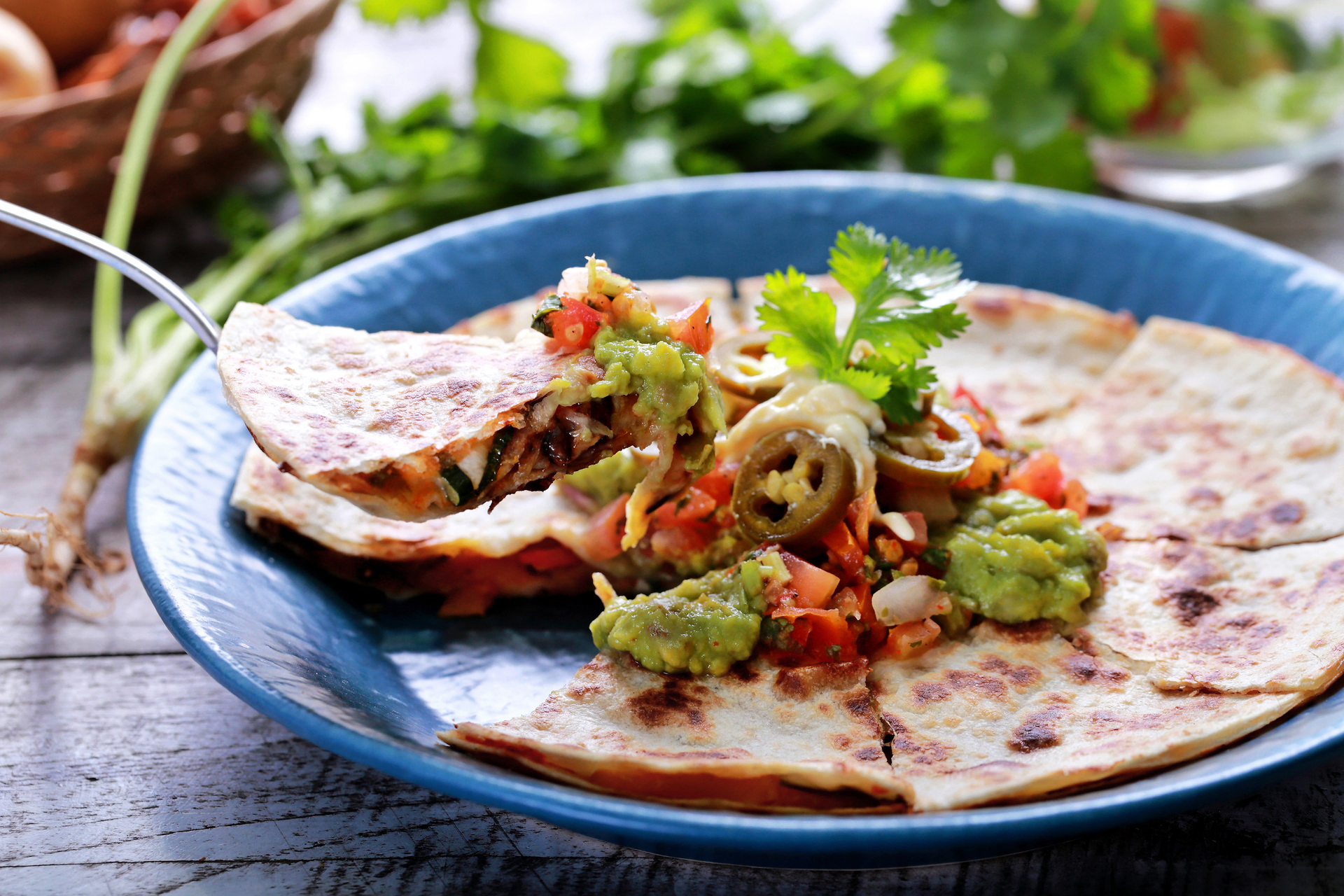 Overhead flat-lay of all ingredients for Savory Mexican Tlayuda with Cactus and Oaxaca Cheese laid out on a kitchen surface.