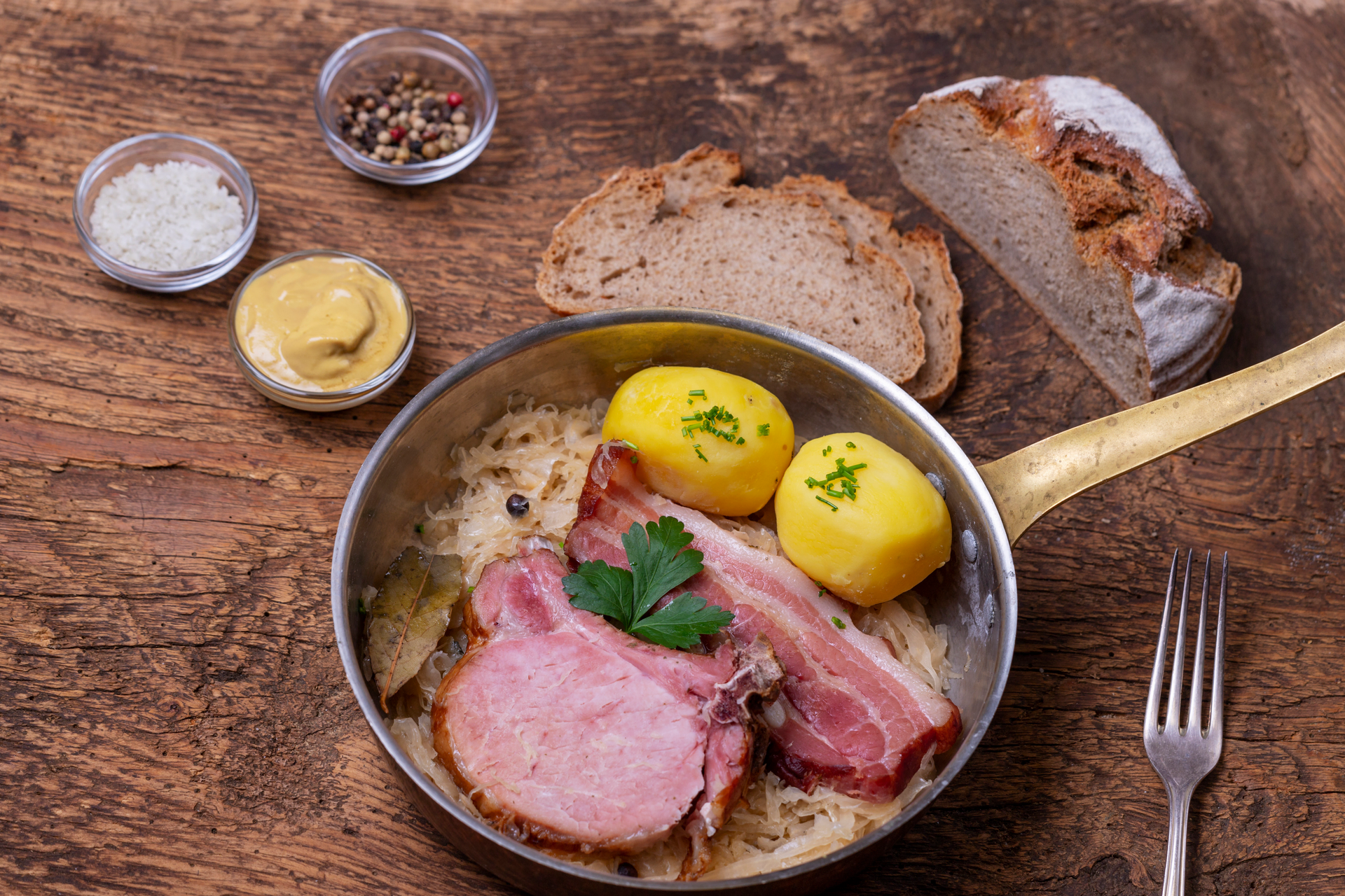 Overhead flat-lay of all ingredients for Polish kielbasa and zurek: a savory smoked sausage soup laid out on a kitchen surface.