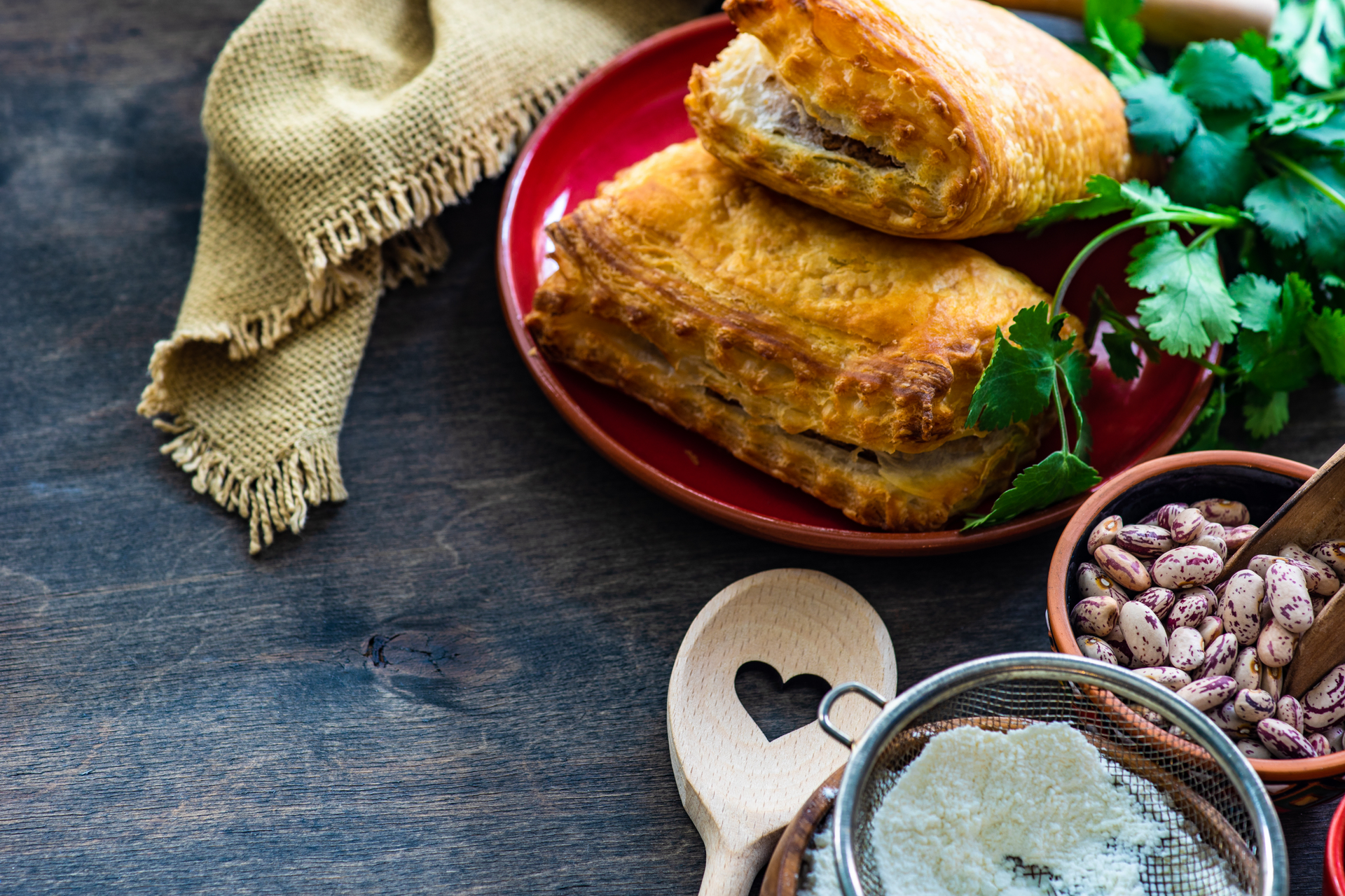 Overhead flat-lay of all ingredients for Savory Serbian Gibanica laid out on a kitchen surface.