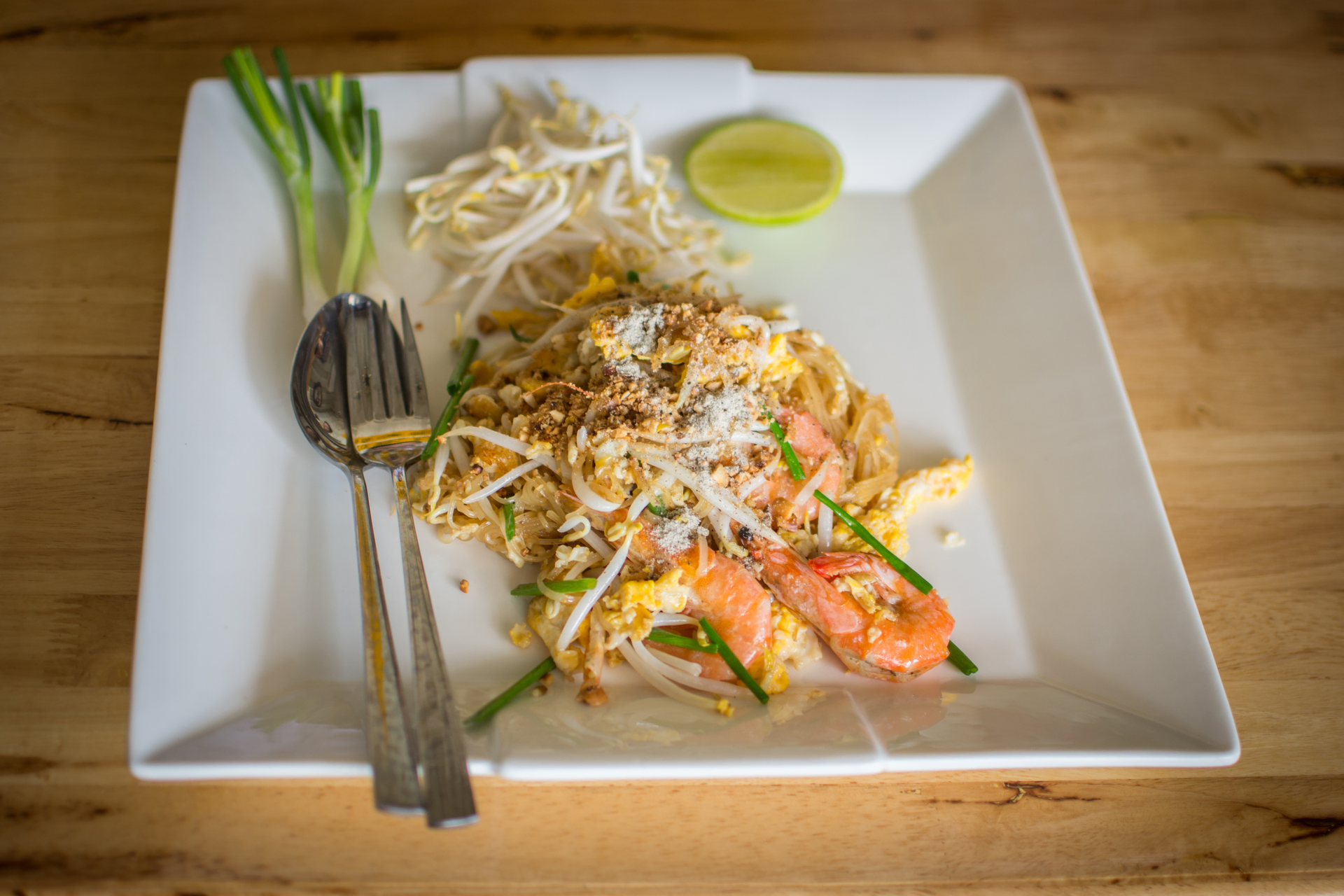 Overhead flat-lay of all ingredients for Savory Thai Khao Soi with Coconut Curry Noodles laid out on a kitchen surface.