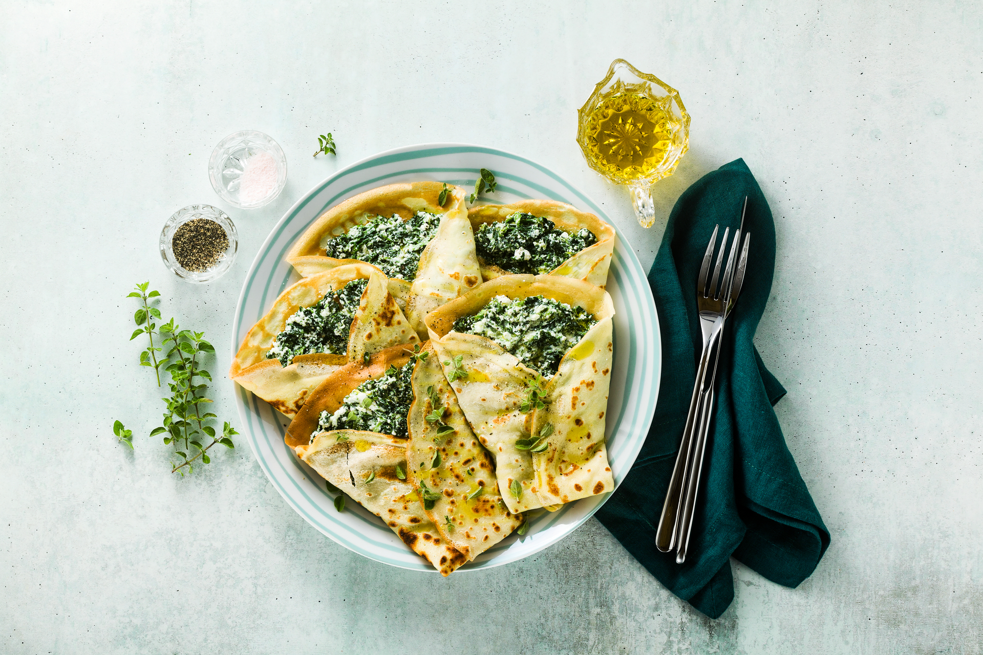 Overhead flat-lay of all ingredients for Savory Turkish Börek with Spinach and Feta laid out on a kitchen surface.