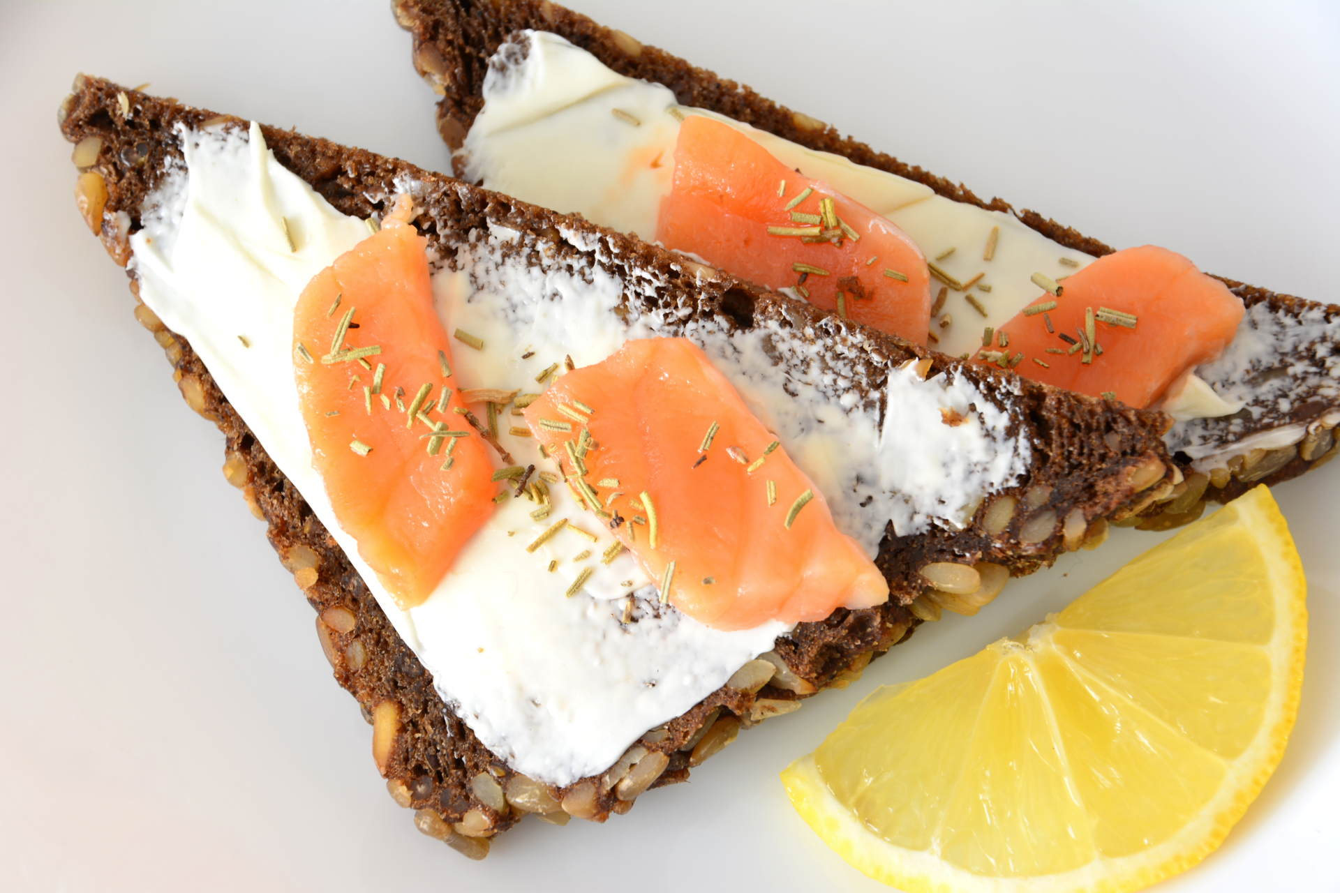 Overhead flat-lay of all ingredients for Scandinavian Skagen Toast with Shrimp on Rye laid out on a kitchen surface.