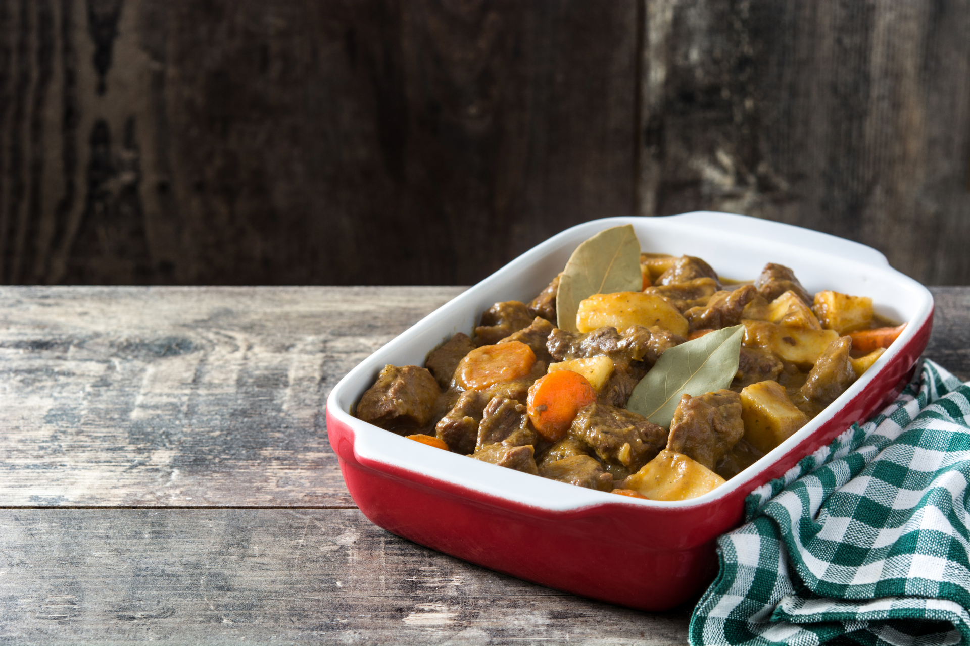 Overhead flat-lay of all ingredients for Scottish Stovies with Lamb and Potatoes laid out on a kitchen surface.